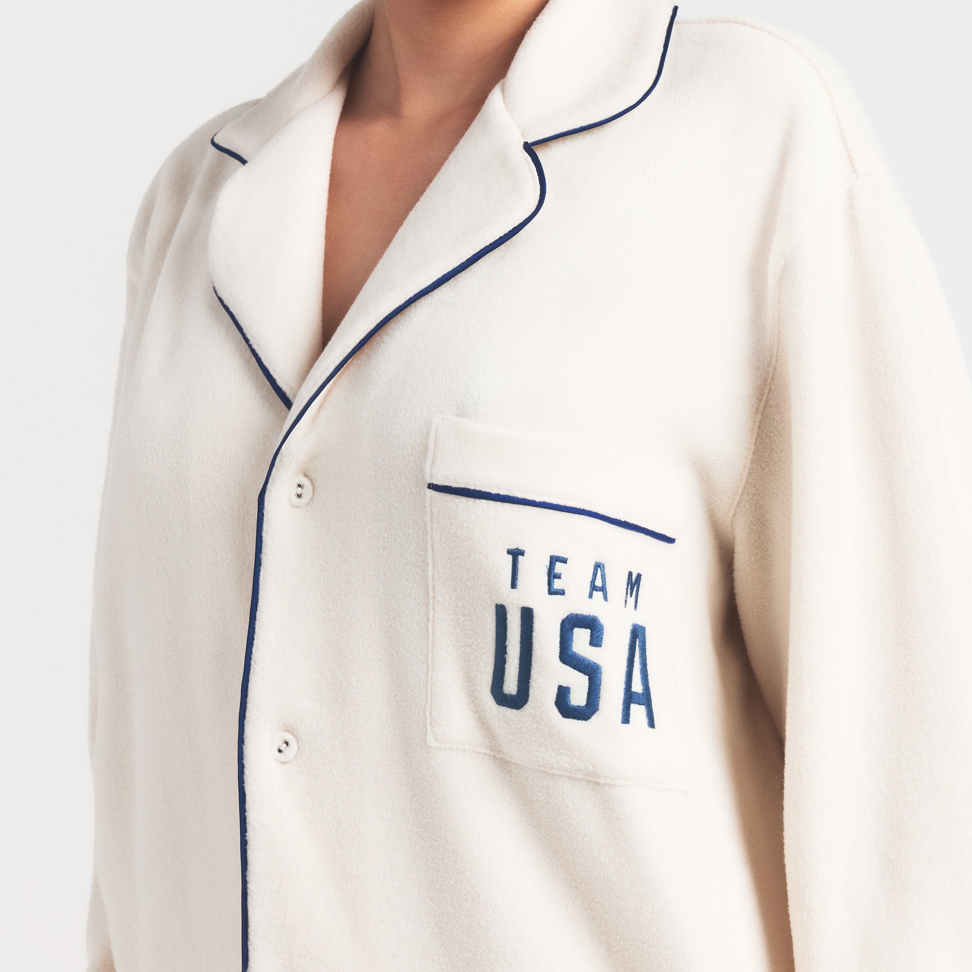 SKIMS FOR TEAM USA UNISEX FLEECE PARALYMPIC OVERSIZED SLEEP TOP | ECRU ON A MODEL SIDE VIEW @ | FOCUS: 0.0, 1.0, 0.9