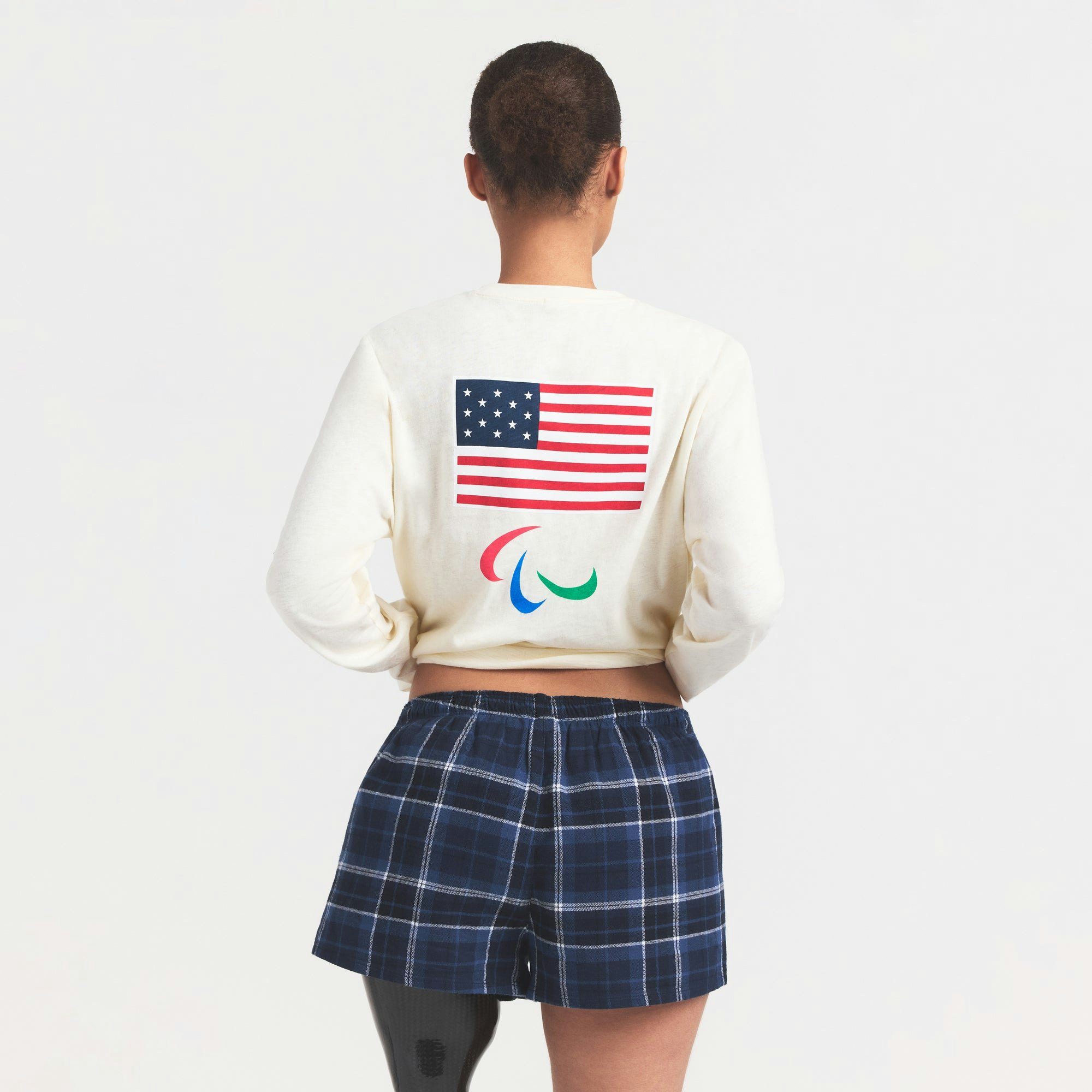 SKIMS FOR TEAM USA WORN IN JERSEY PARALYMPIC LONG SLEEVE T-SHIRT | ECRU ON A MODEL SIDE VIEW @ | FOCUS: 0.0, 1.0, 0.9