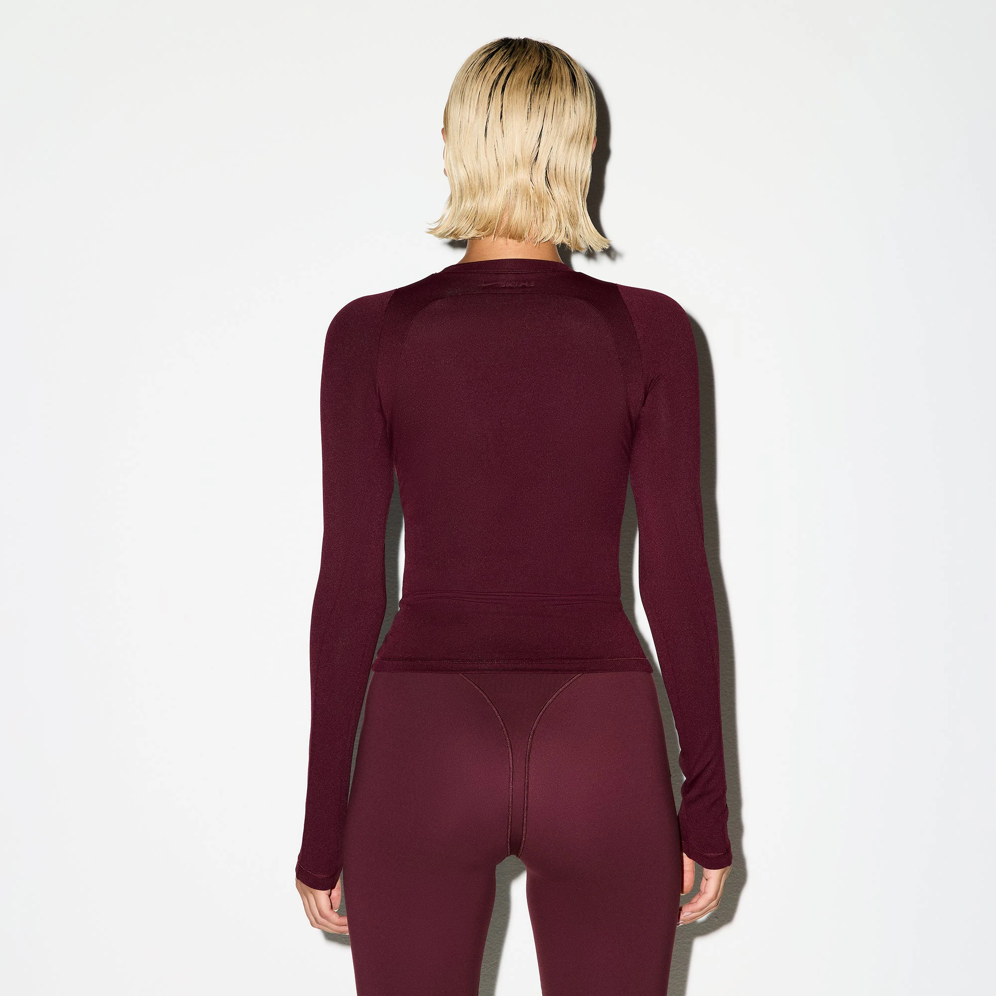 NikeSKIMS AIRY LONG SLEEVE CREW NECK TOP | CURRANT ON A MODEL BACK VIEW @ | FOCUS: 0.0, 1.0, 0.9