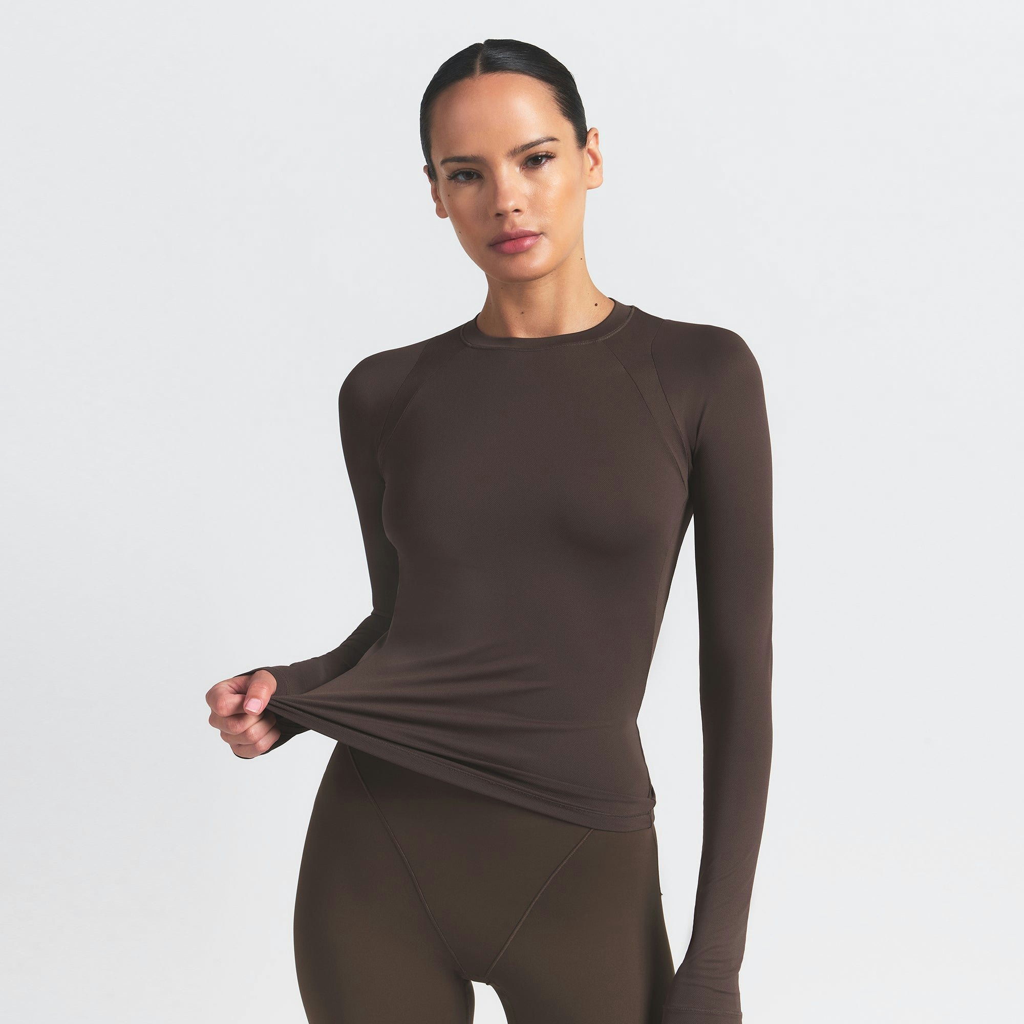 NikeSKIMS AIRY LONG SLEEVE CREW NECK TOP | DARK SEPIA ON A MODEL SIDE VIEW @ | FOCUS: 0.9, 0.1, 0.7