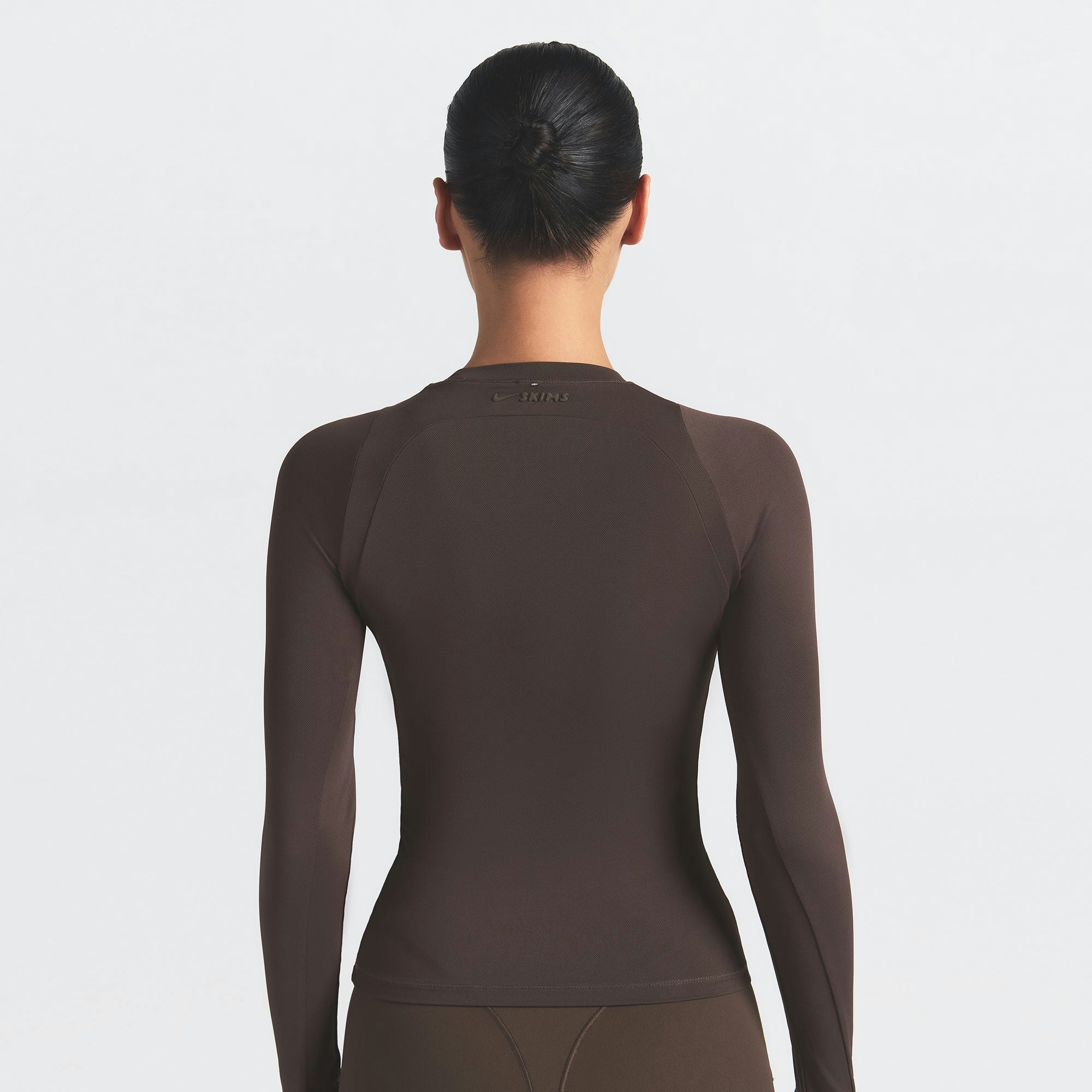 NikeSKIMS AIRY LONG SLEEVE CREW NECK TOP | DARK SEPIA ON A MODEL SIDE VIEW @ | FOCUS: 0.9, 0.1, 0.7