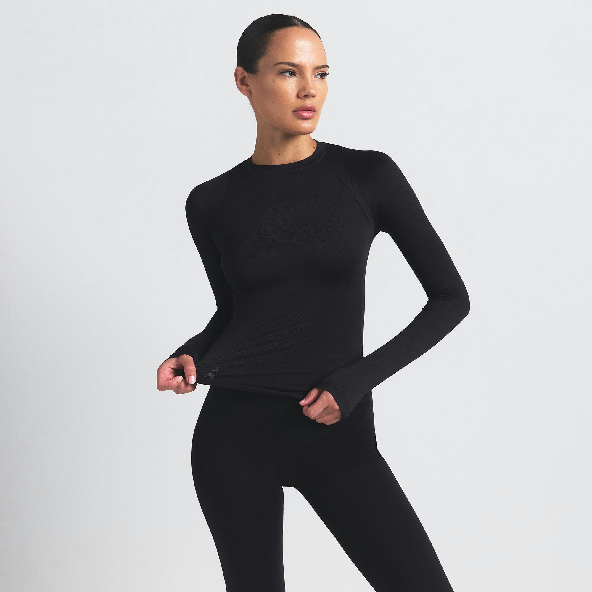 NikeSKIMS AIRY LONG SLEEVE CREW NECK TOP | OBSIDIAN ON A MODEL SIDE VIEW @ | FOCUS: 0.9, 0.1, 0.7