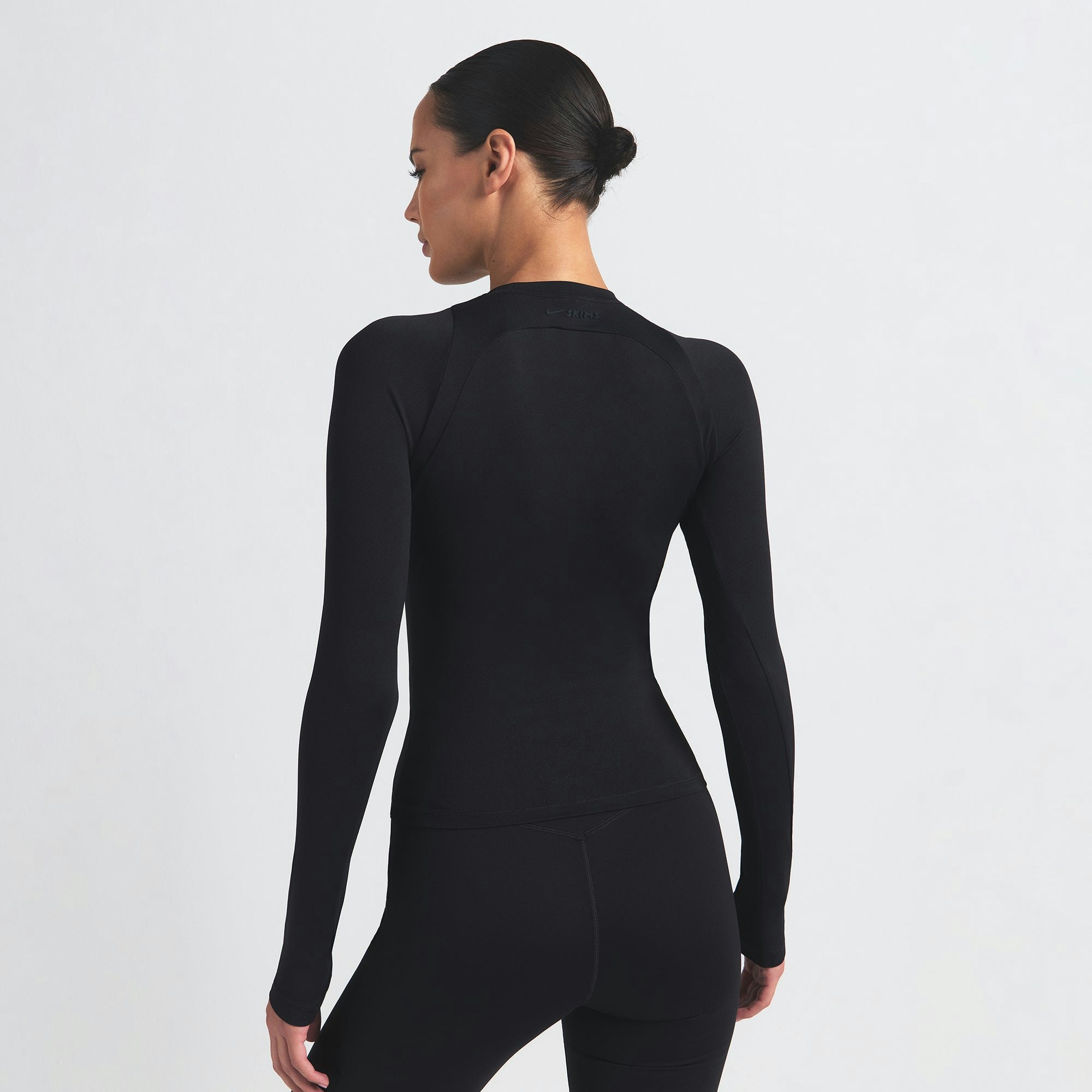 NikeSKIMS AIRY LONG SLEEVE CREW NECK TOP | OBSIDIAN ON A MODEL SIDE VIEW @ | FOCUS: 0.9, 0.1, 0.7
