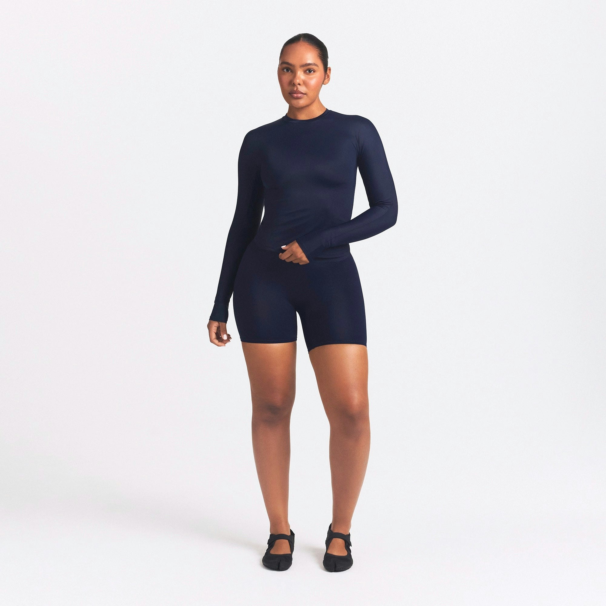 NikeSKIMS SHINE LONG SLEEVE CREW NECK TOP | NAVY ON A MODEL FRONT VIEW @ | FOCUS: 0.0, 1.0, 0.9