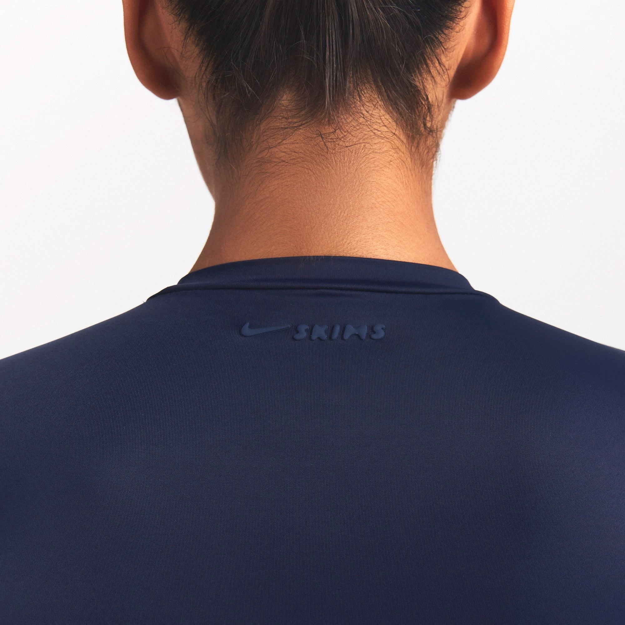 NikeSKIMS SHINE LONG SLEEVE CREW NECK TOP | NAVY ON A MODEL SIDE VIEW @ | FOCUS: 0.0, 1.0, 0.9