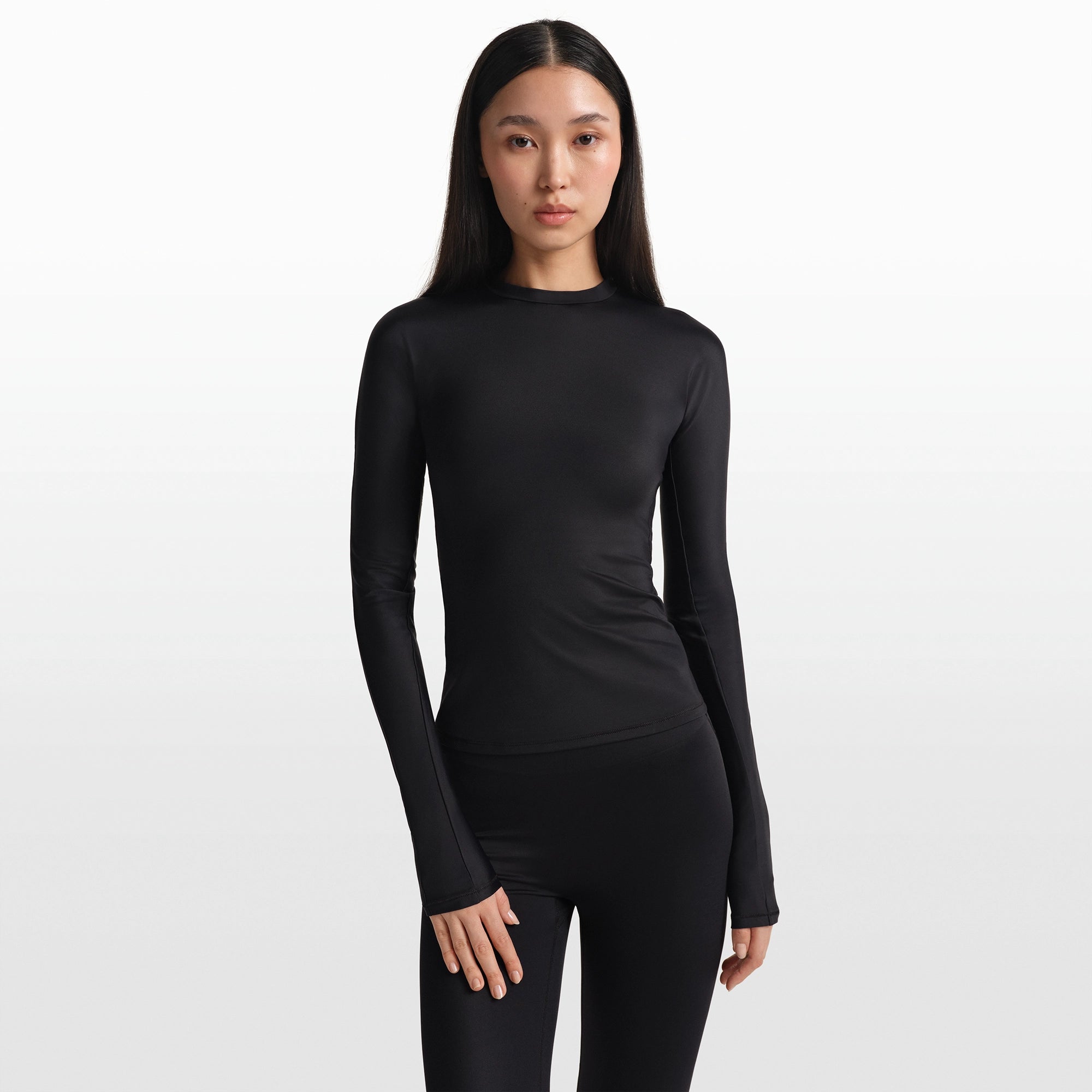 NikeSKIMS SHINE LONG SLEEVE CREW NECK TOP | OBSIDIAN ON A MODEL FRONT VIEW