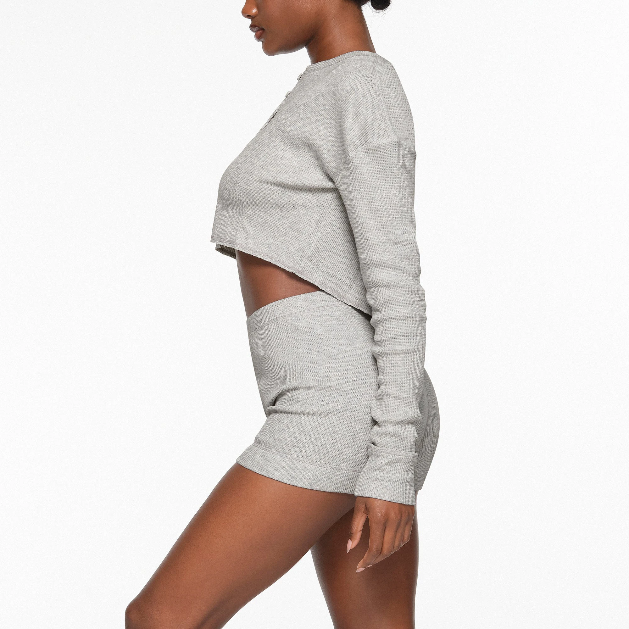 WAFFLE HENLEY CROPPED LONG SLEEVE WORN BY A MODEL IN SIDE VIEW