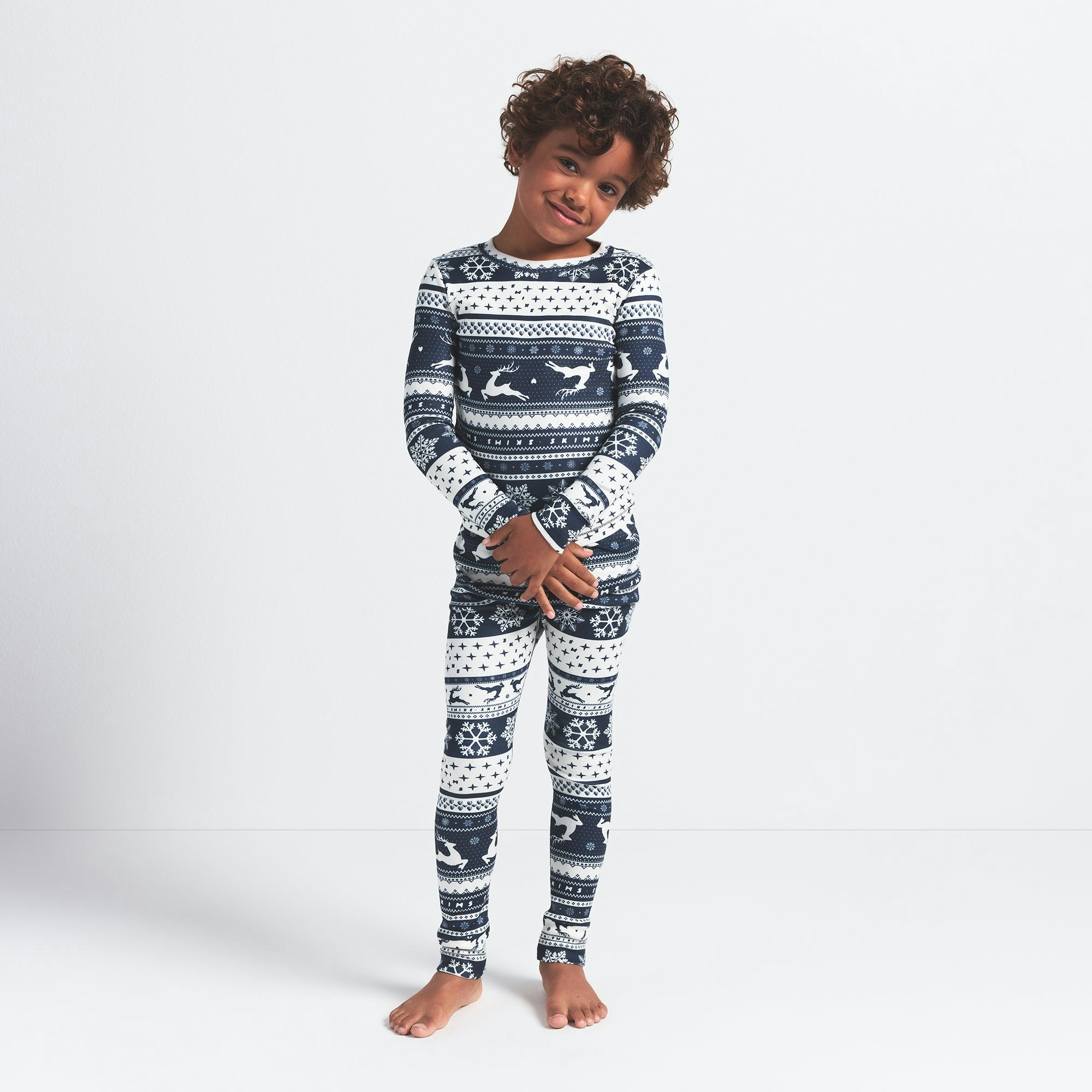 LOGO PLUSH POINTELLE KIDS LONG SLEEVE SET | NAVY DEER FAIR ISLE ON A MODEL FRONT VIEW