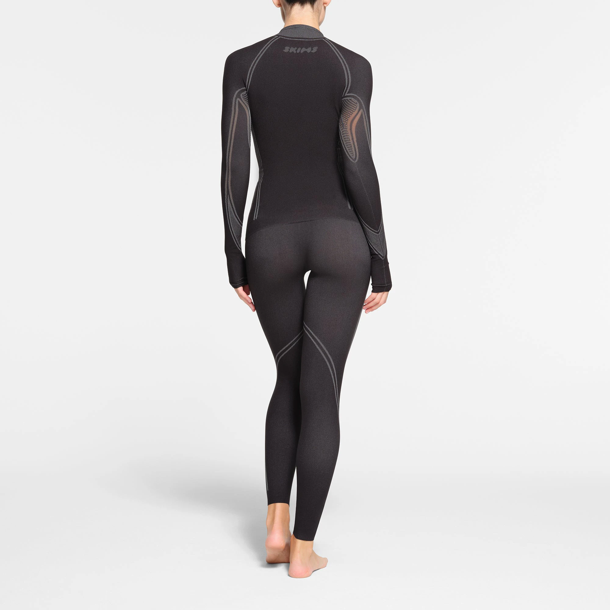 SKIMS FIRST LAYERS TURTLENECK TOP | ONYX ON A MODEL BACK VIEW