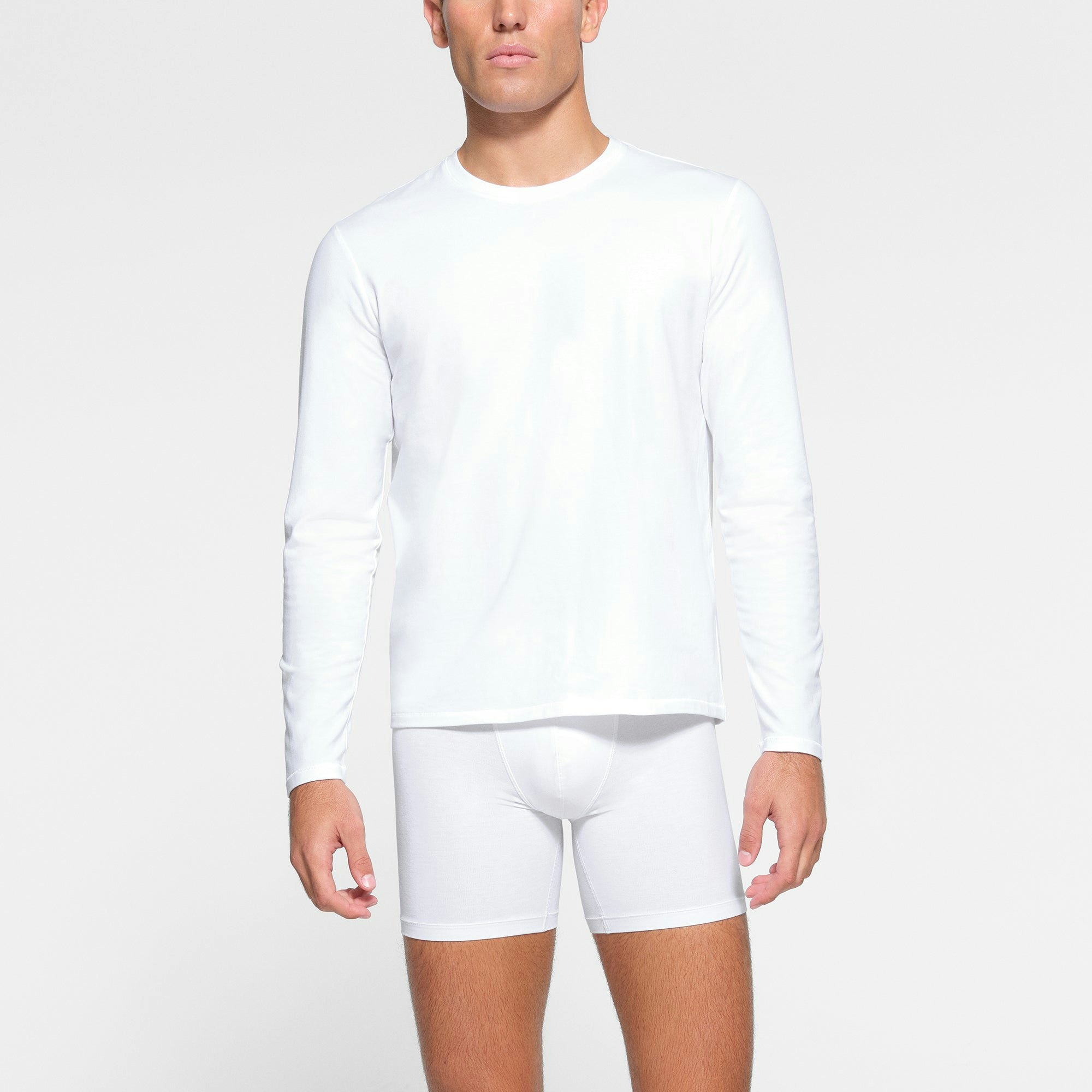 SKIMS COTTON MENS LONG SLEEVE T-SHIRT WORN BY A MODEL IN FRONT VIEW