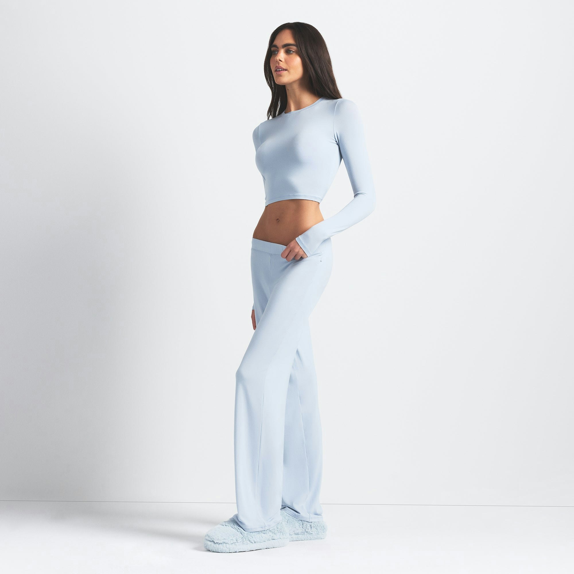 SKIMS SLEEP SUPER CROPPED LONG SLEEVE | ZEN BLUE ON A MODEL SIDE VIEW @ | FOCUS: 0.0, 1.0, 0.9
