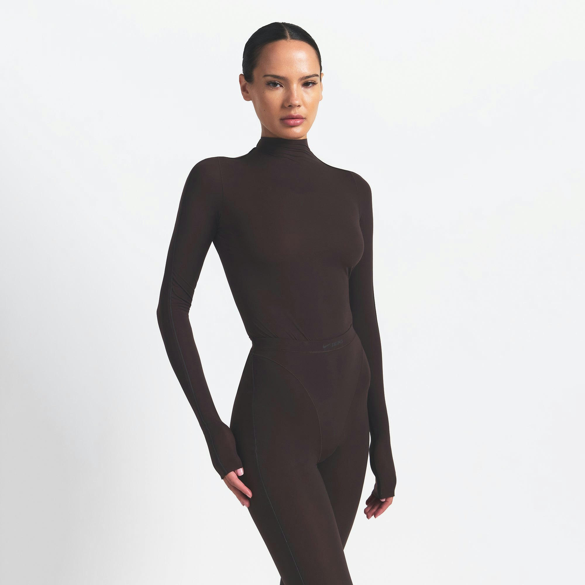 NikeSKIMS WEIGHTLESS LAYERS MOCK NECK LONG SLEEVE TOP | DARK ROAST ON A MODEL FRONT VIEW @ | FOCUS: 0.0, 1.0, 0.9