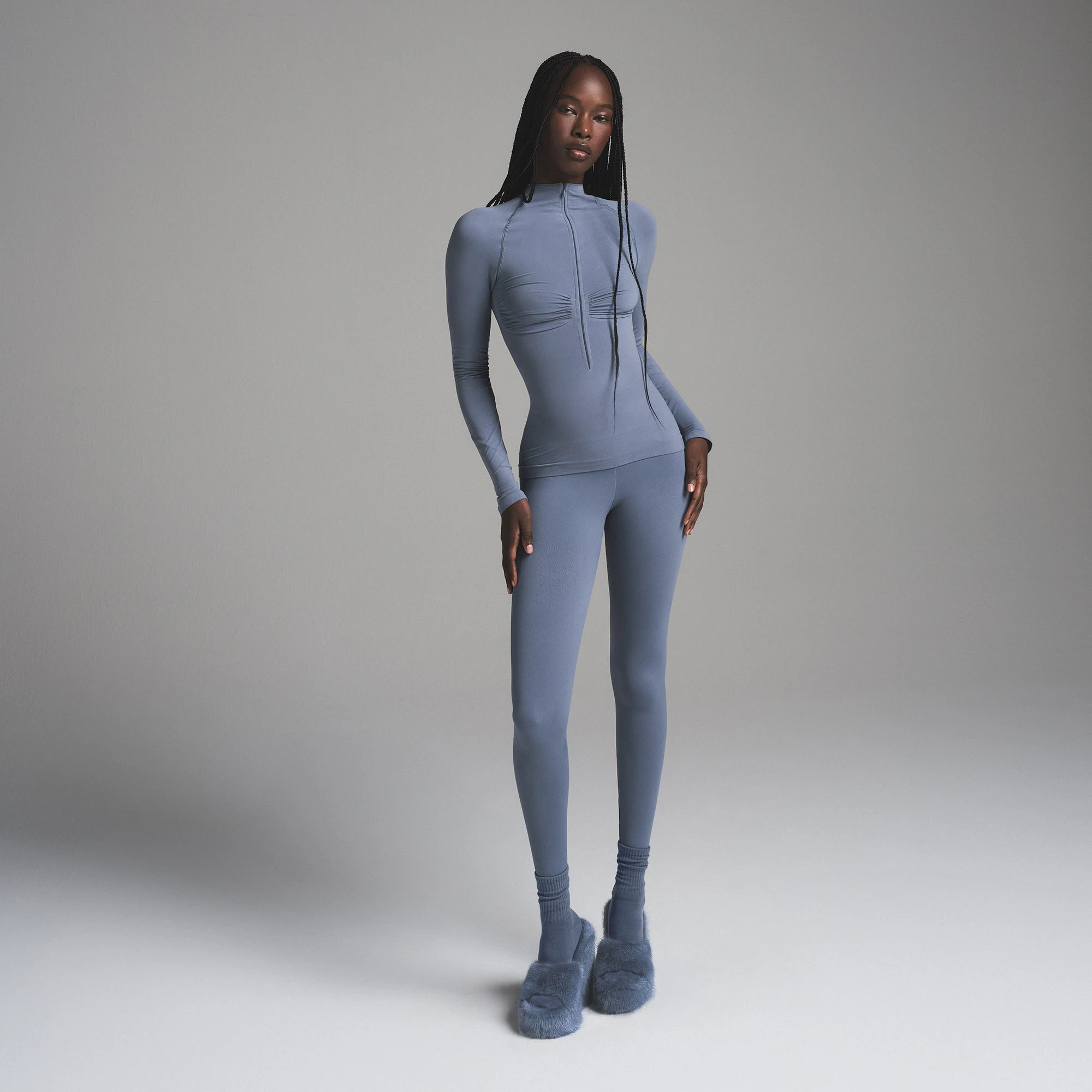 SEAMLESS SCULPT MOCK NECK LONG SLEEVE T-SHIRT | STEEL BLUE ON A MODEL FRONT VIEW| FOCUS: 0.9, 0.9, 0.9