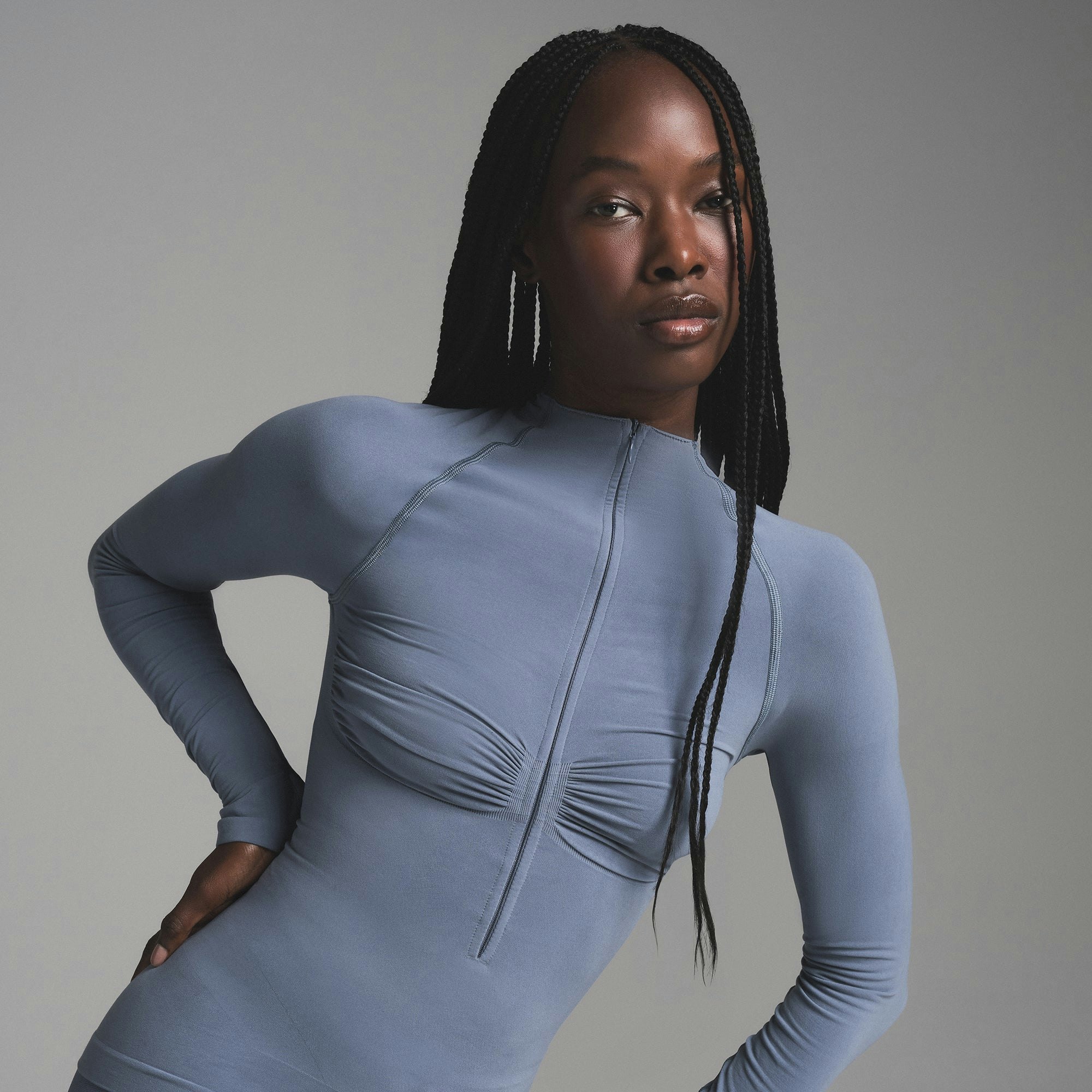 SEAMLESS SCULPT MOCK NECK LONG SLEEVE T-SHIRT | STEEL BLUE ON A MODEL SIDE VIEW | FOCUS: 0.0, 1.0, 0.9