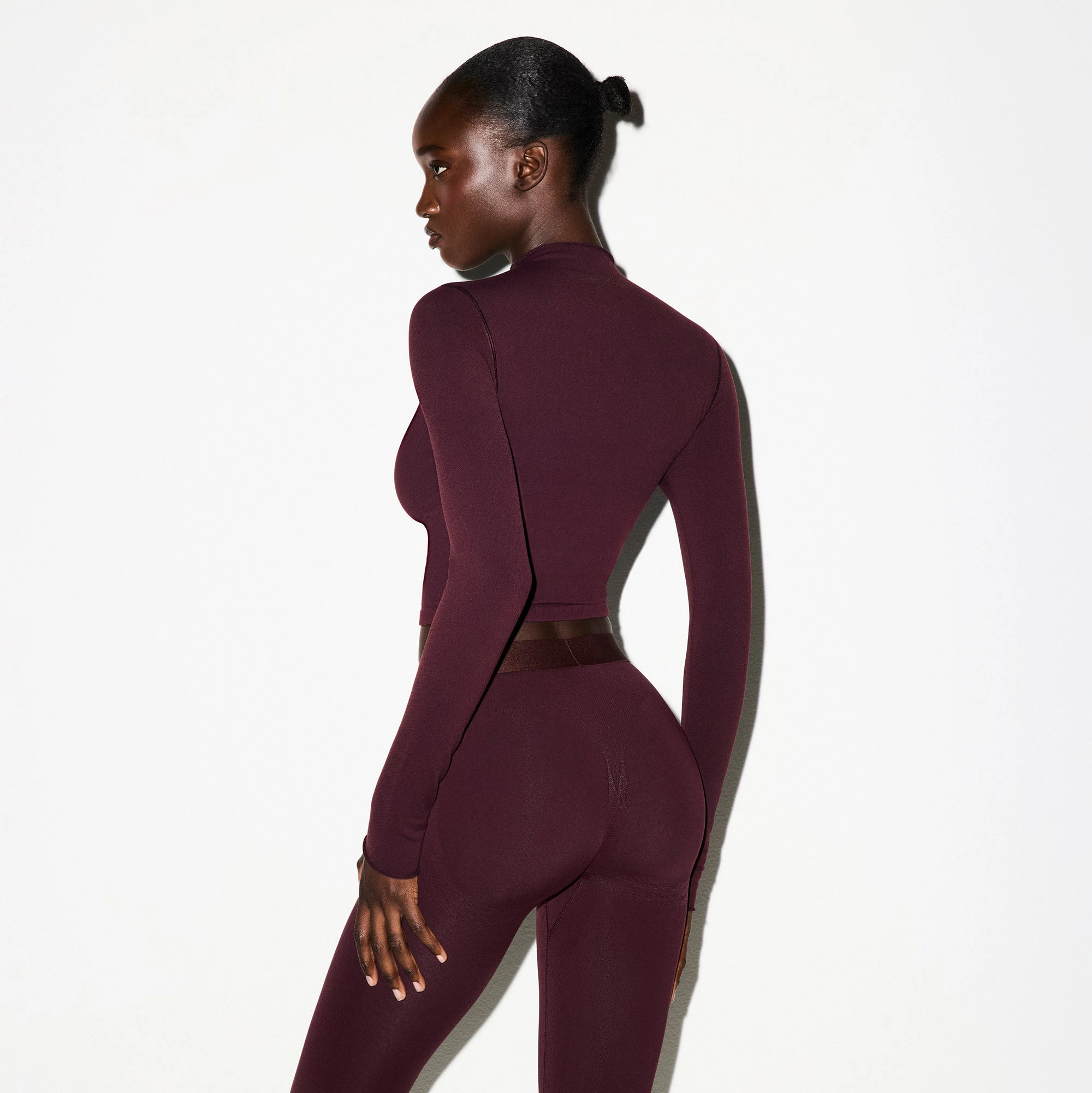 NikeSKIMS VINTAGE SEAMLESS MOCK NECK CROP TOP | CURRANT ON A MODEL FRONT VIEW @ | FOCUS: 0.0, 1.0, 0.9