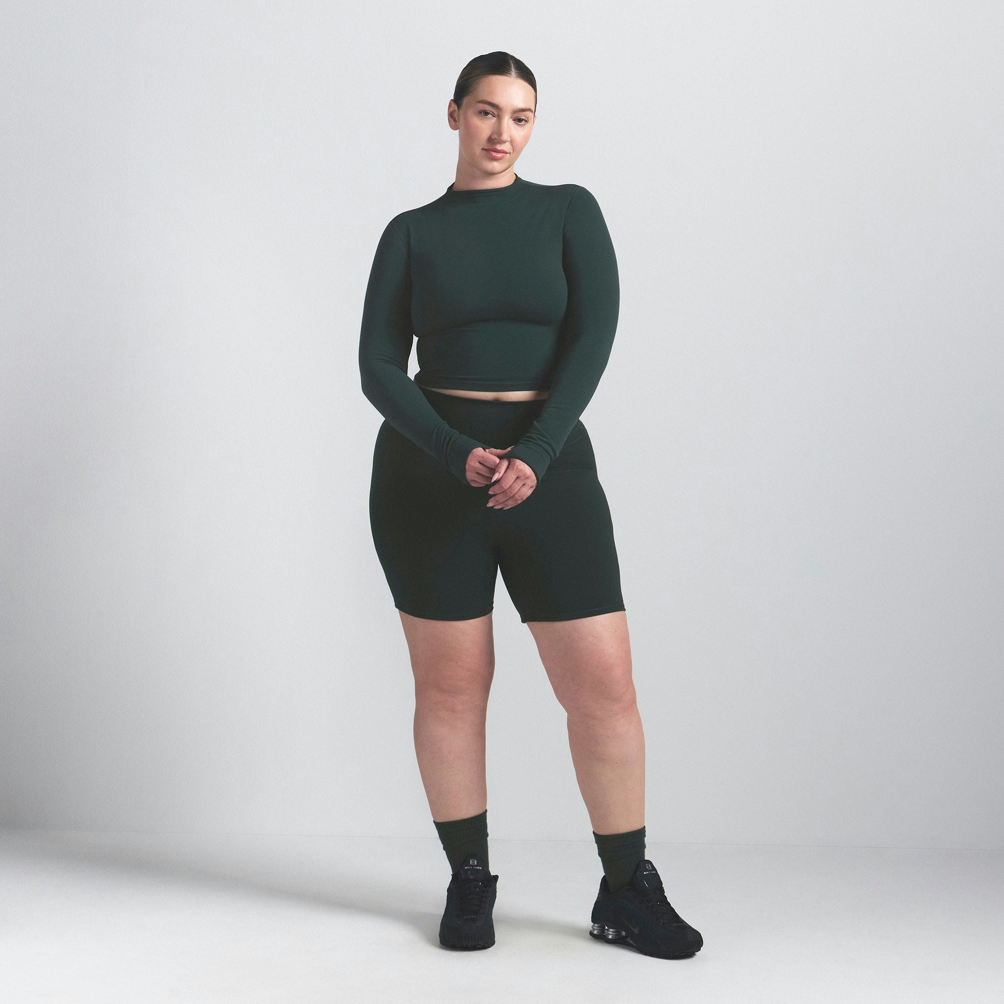 NikeSKIMS VINTAGE SEAMLESS MOCK NECK CROP TOP | DARK TEAL ON A MODEL FRONT VIEW @ | FOCUS: 0.0, 1.0, 0.9