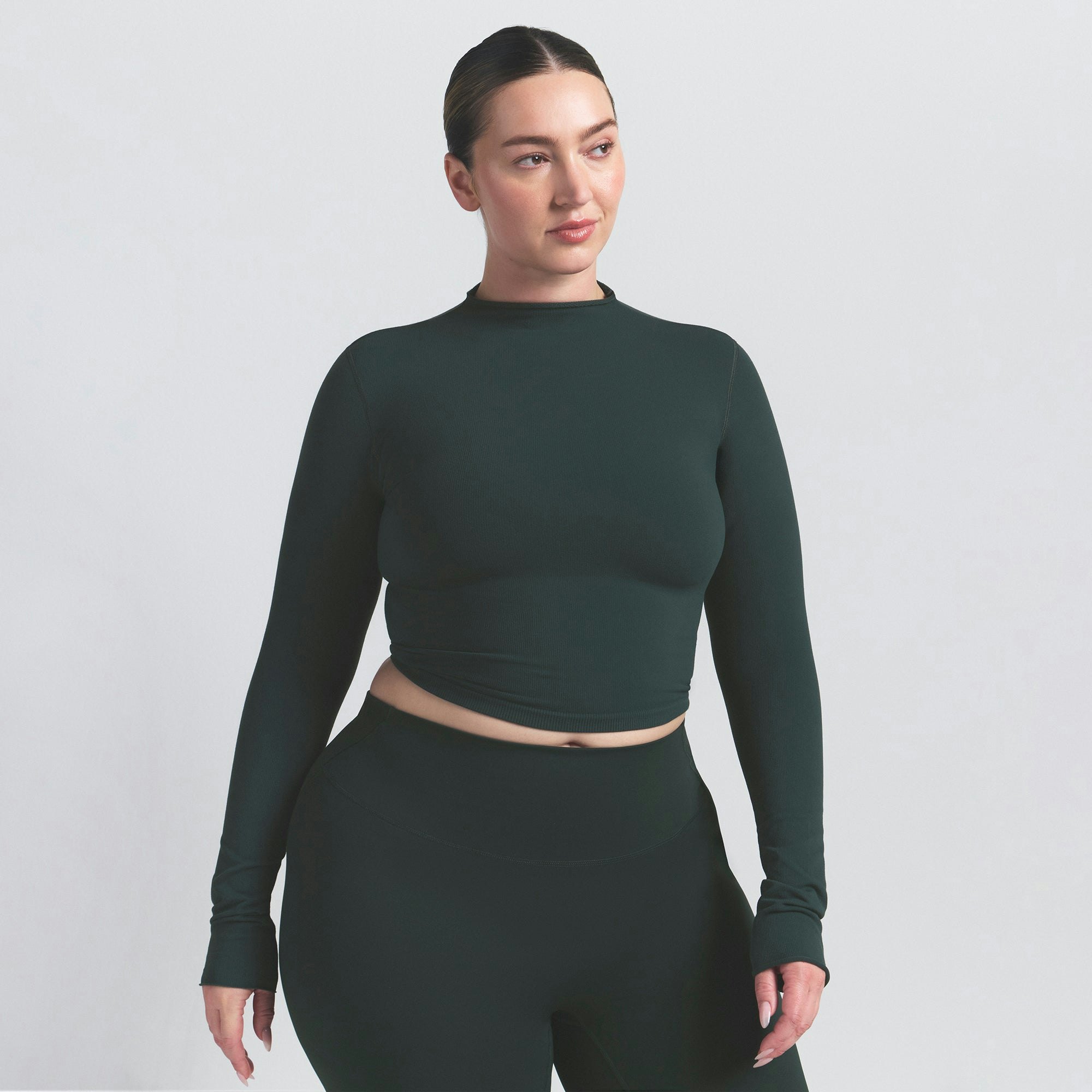 NikeSKIMS VINTAGE SEAMLESS MOCK NECK CROP TOP | DARK TEAL ON A MODEL SIDE VIEW @ | FOCUS: 0.0, 1.0, 0.9