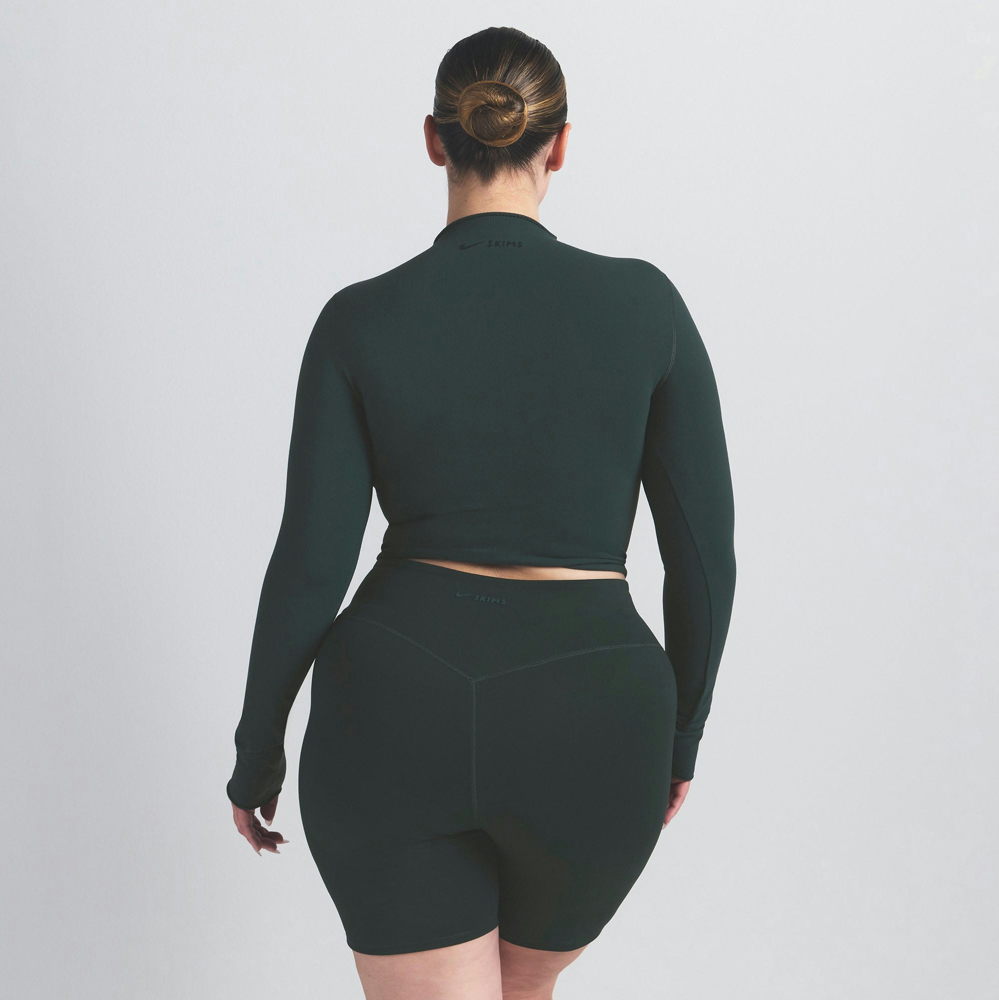 NikeSKIMS VINTAGE SEAMLESS MOCK NECK CROP TOP | DARK TEAL ON A MODEL SIDE VIEW @ | FOCUS: 0.0, 1.0, 0.9