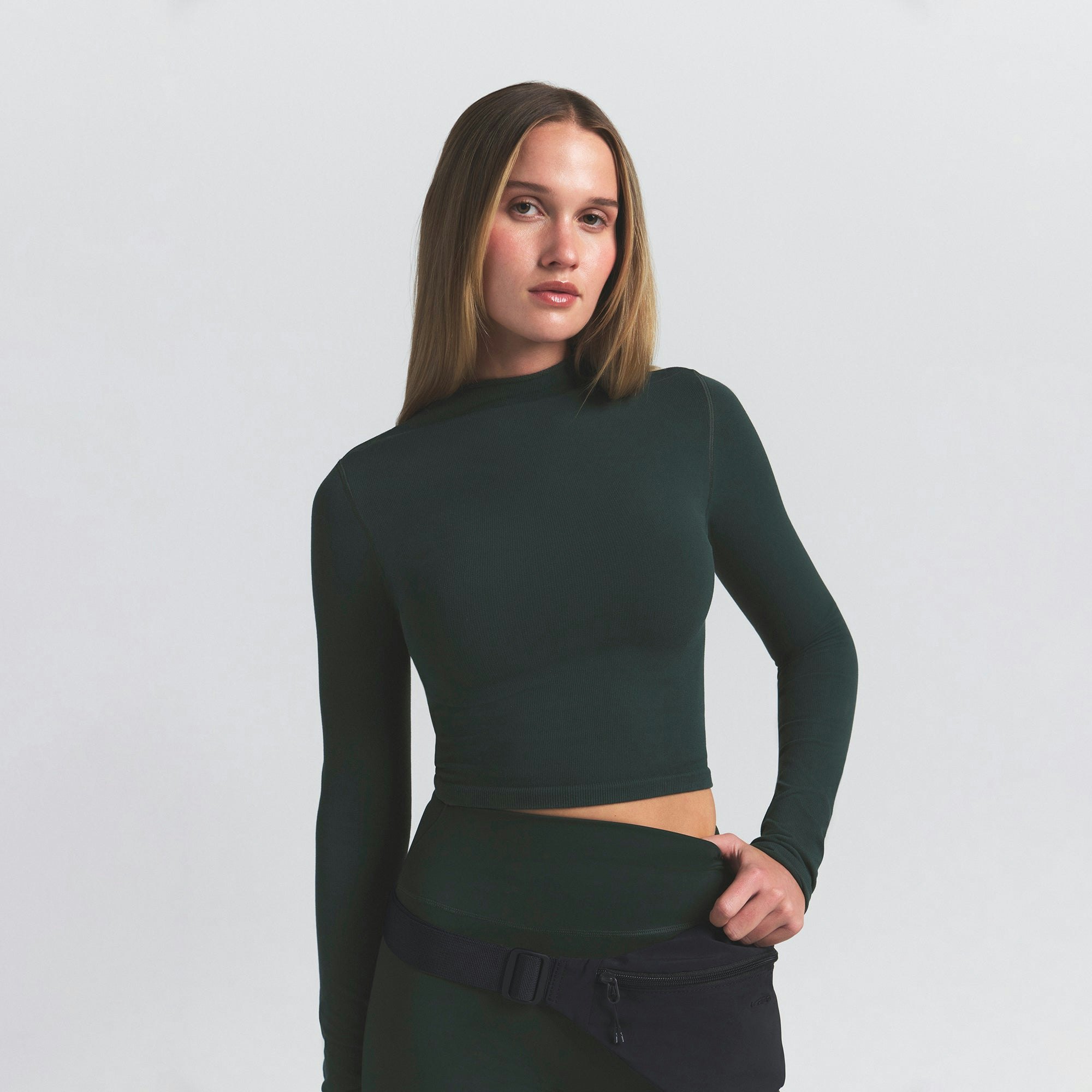 NikeSKIMS VINTAGE SEAMLESS MOCK NECK CROP TOP | DARK TEAL ON A MODEL SIDE VIEW @ | FOCUS: 0.0, 1.0, 0.9
