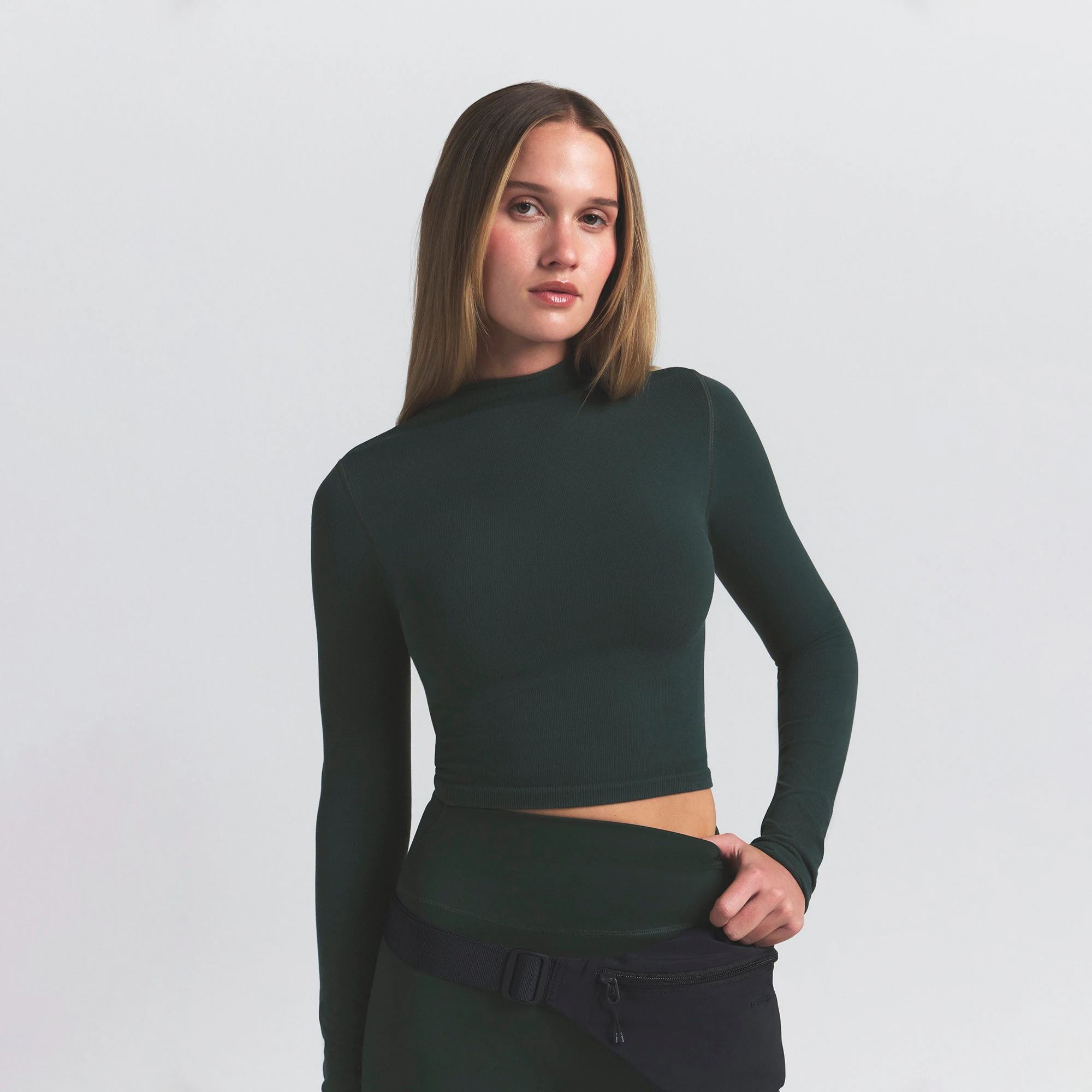 NikeSKIMS VINTAGE SEAMLESS MOCK NECK CROP TOP | DARK TEAL ON A MODEL SIDE VIEW @ | FOCUS: 0.0, 1.0, 0.9