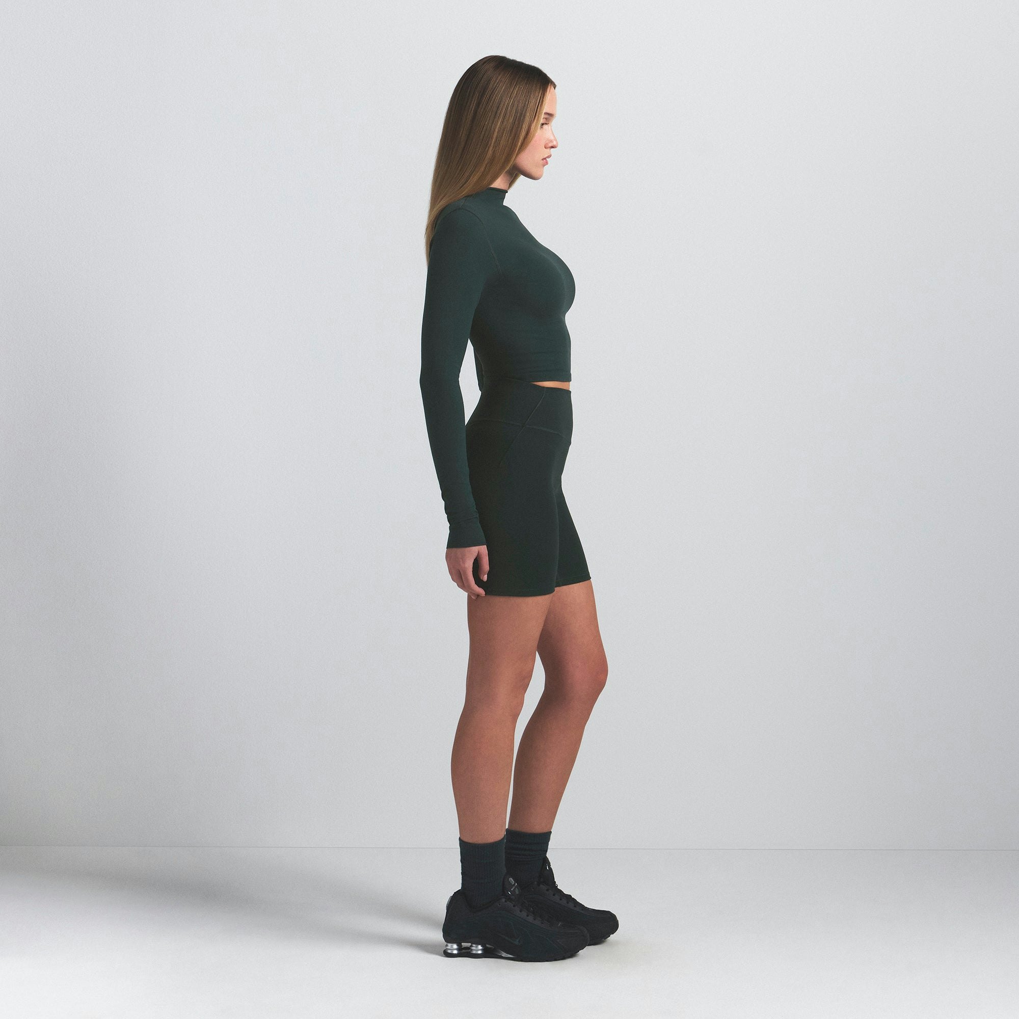 NikeSKIMS VINTAGE SEAMLESS MOCK NECK CROP TOP | DARK TEAL ON A MODEL SIDE VIEW @ | FOCUS: 0.0, 1.0, 0.9