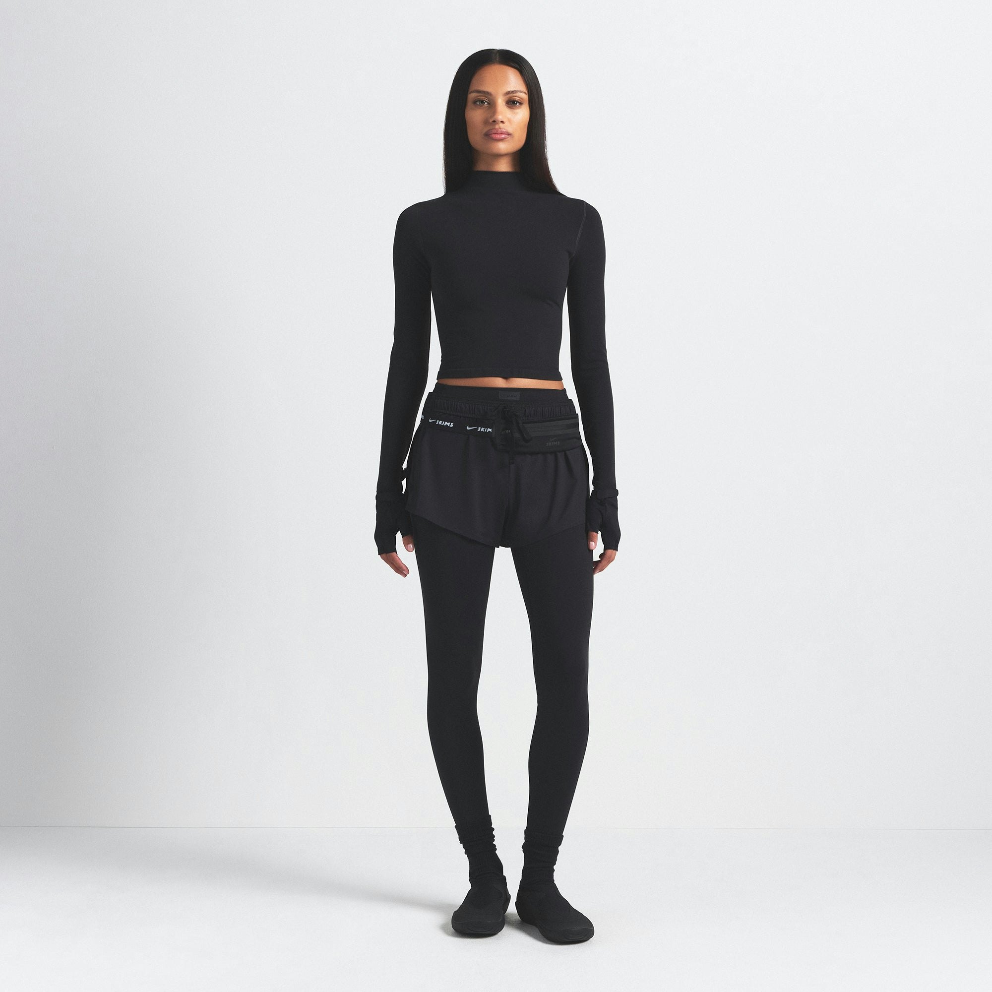 NikeSKIMS VINTAGE SEAMLESS MOCK NECK CROP TOP | OBSIDIAN ON A MODEL FRONT VIEW @ | FOCUS: 0.9, 0.1, 0.7