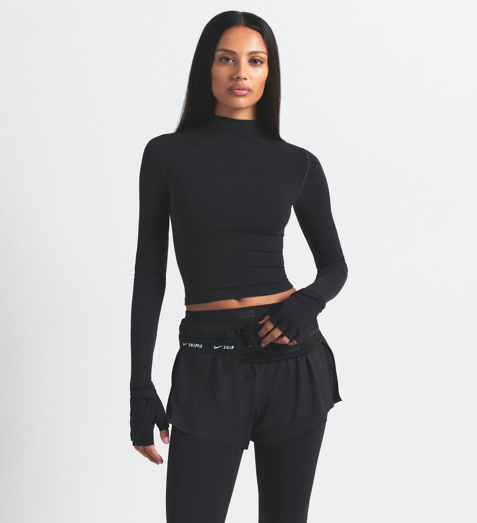 NikeSKIMS VINTAGE SEAMLESS MOCK NECK CROP TOP | OBSIDIAN ON A MODEL SIDE VIEW @ | FOCUS: 0.9, 0.1, 0.7