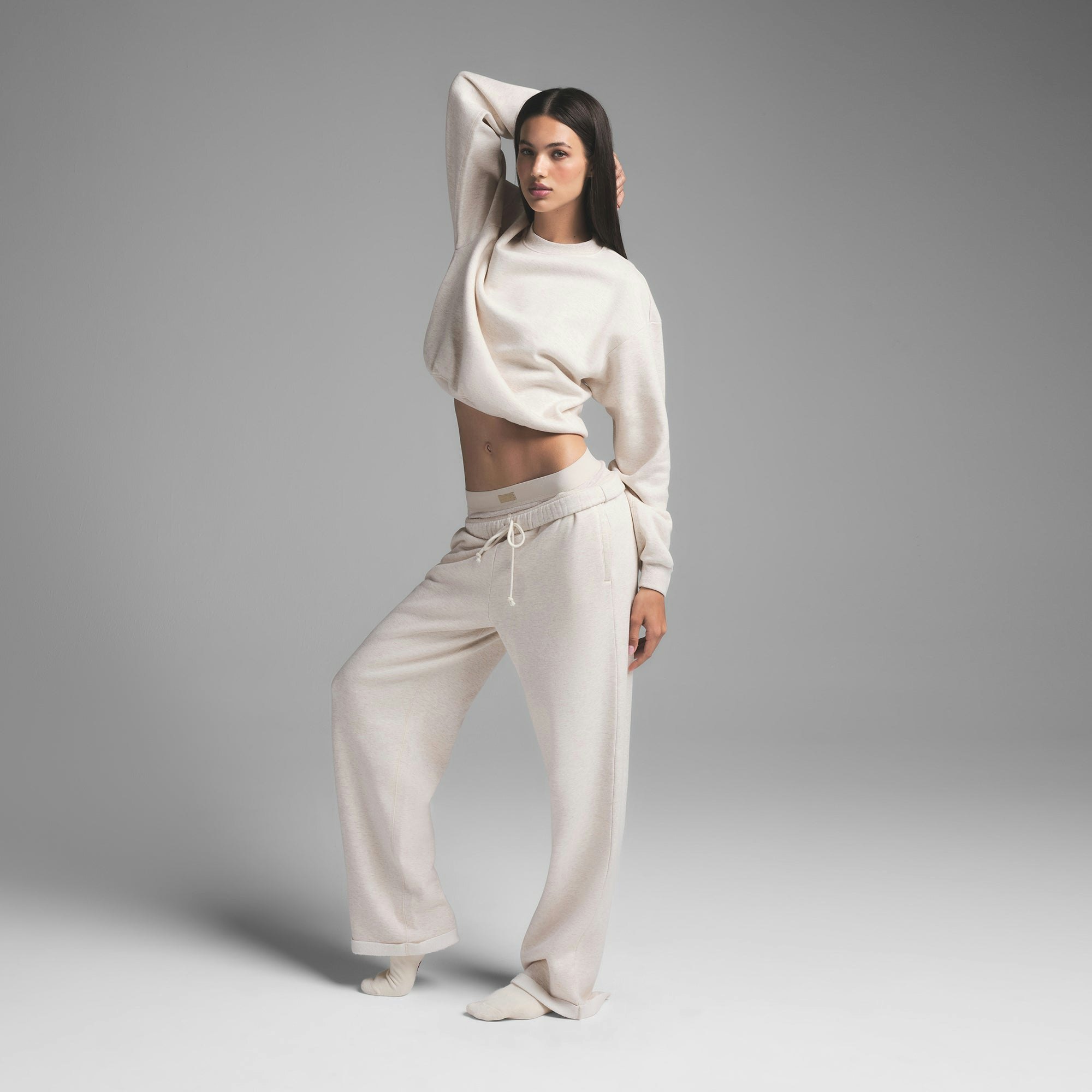 COTTON FLEECE CLASSIC CREWNECK | HEATHER OATMEAL ON A MODEL SIDE VIEW