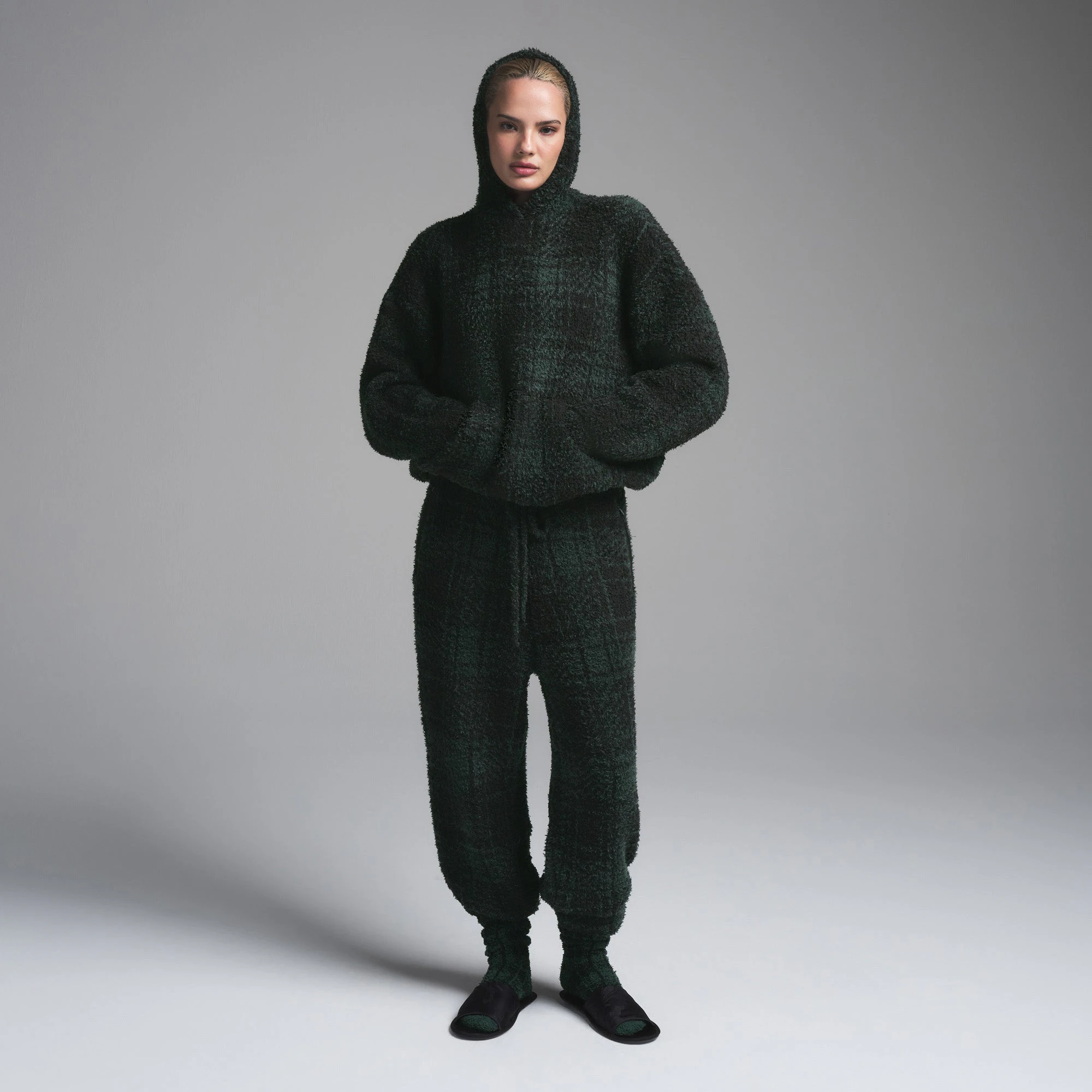 COZY KNIT KNIT UNISEX HOODIE | CYPRESS PLAID ON A MODEL FRONT VIEW | FOCUS: 0.0, 1.0, 0.9