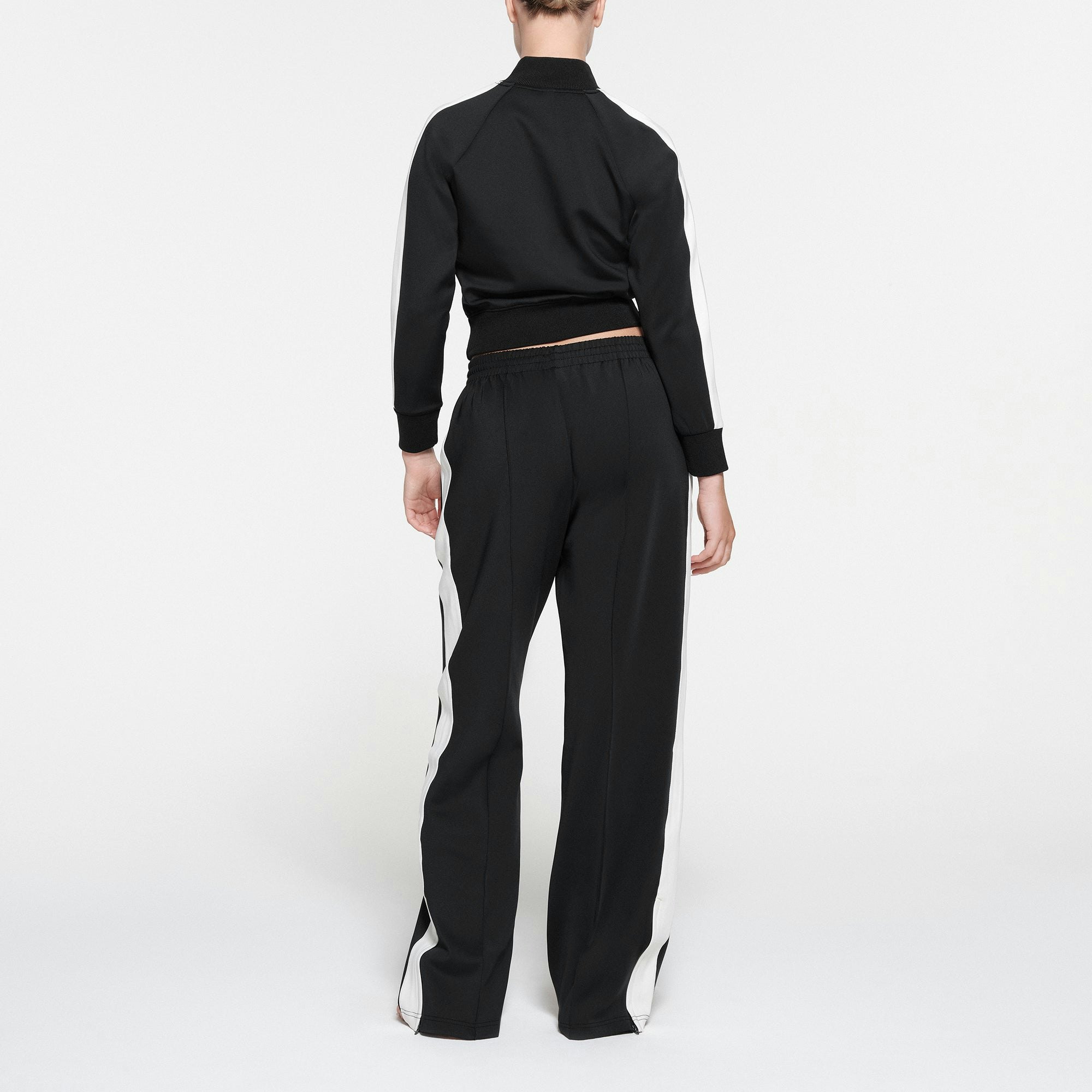 SKIMS TRACK JACKET | ONYX ON A MODEL BACK VIEW