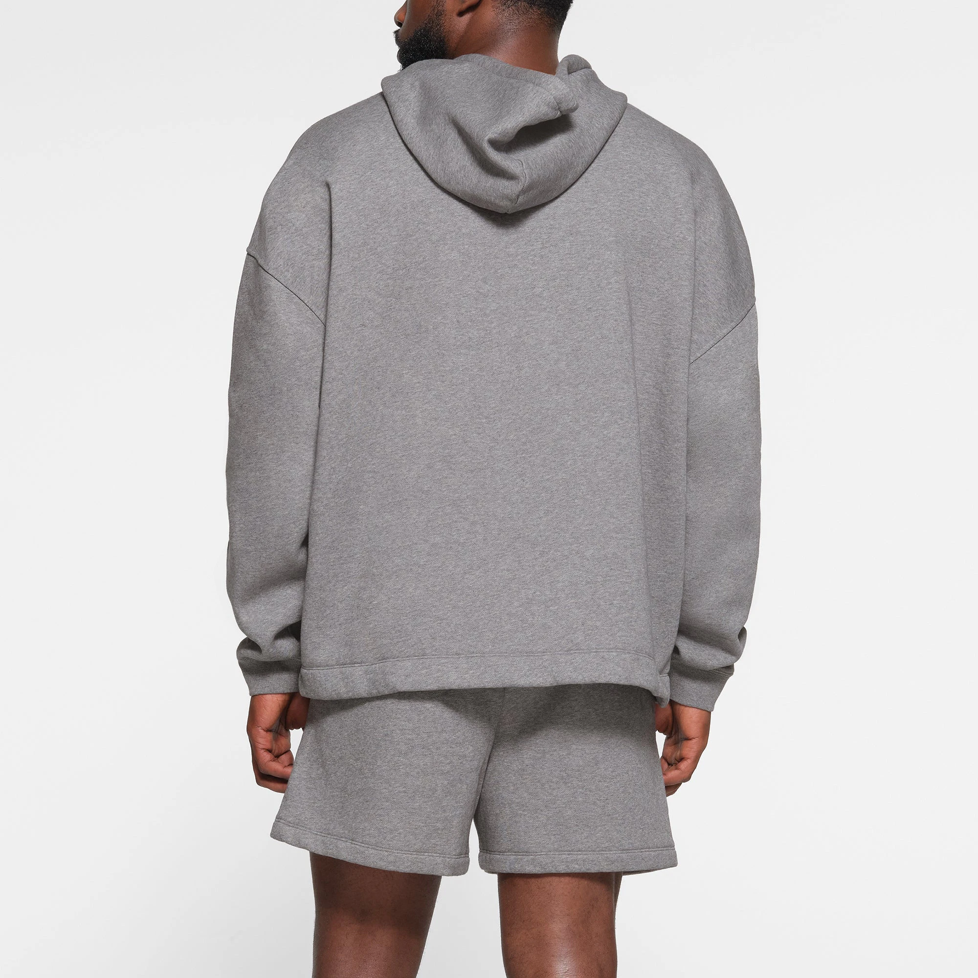 LOUNGE FLEECE MENS RELAXED HOODIE | DARK HEATHER GREY ON A MODEL BACK VIEW