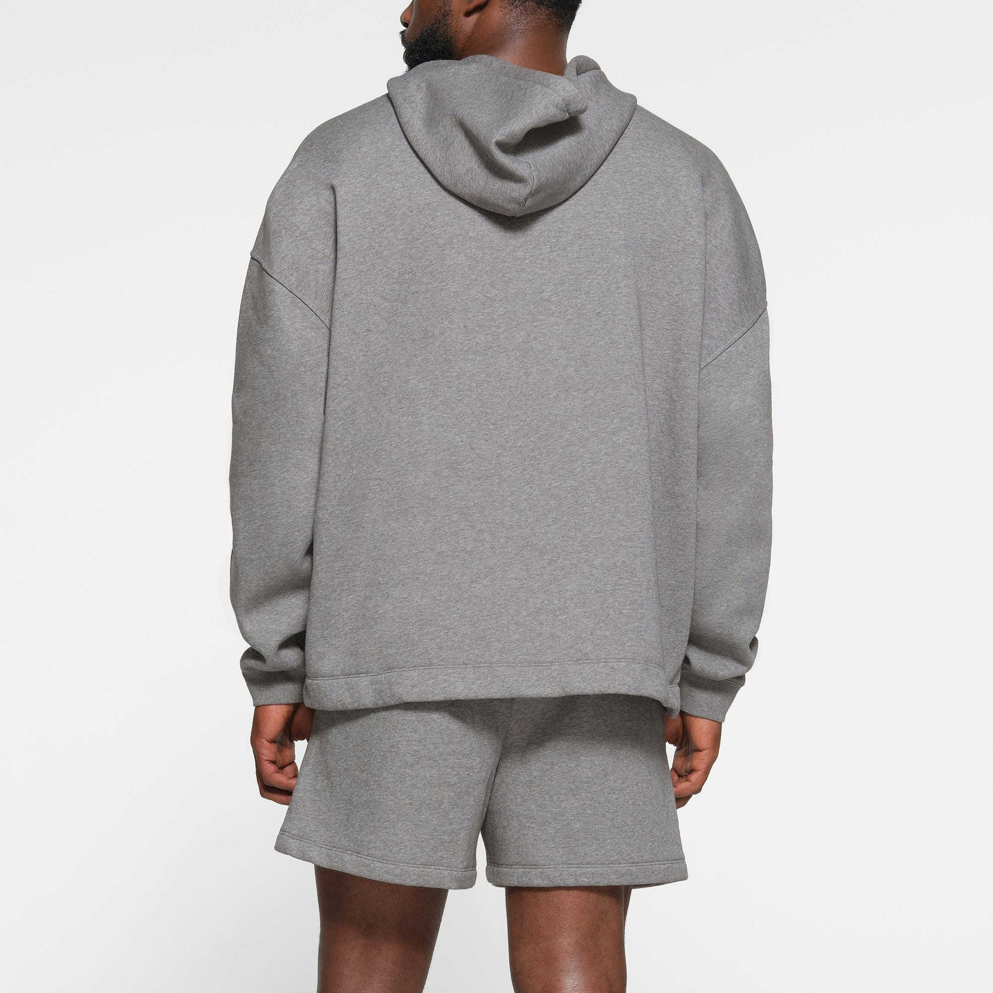 LOUNGE FLEECE MENS RELAXED HOODIE | DARK HEATHER GREY ON A MODEL BACK VIEW