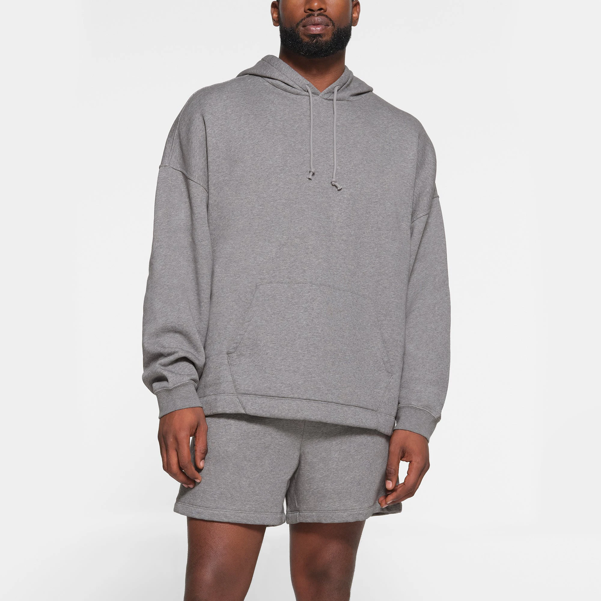 LOUNGE FLEECE MENS RELAXED HOODIE | DARK HEATHER GREY ON A MODEL FRONT VIEW
