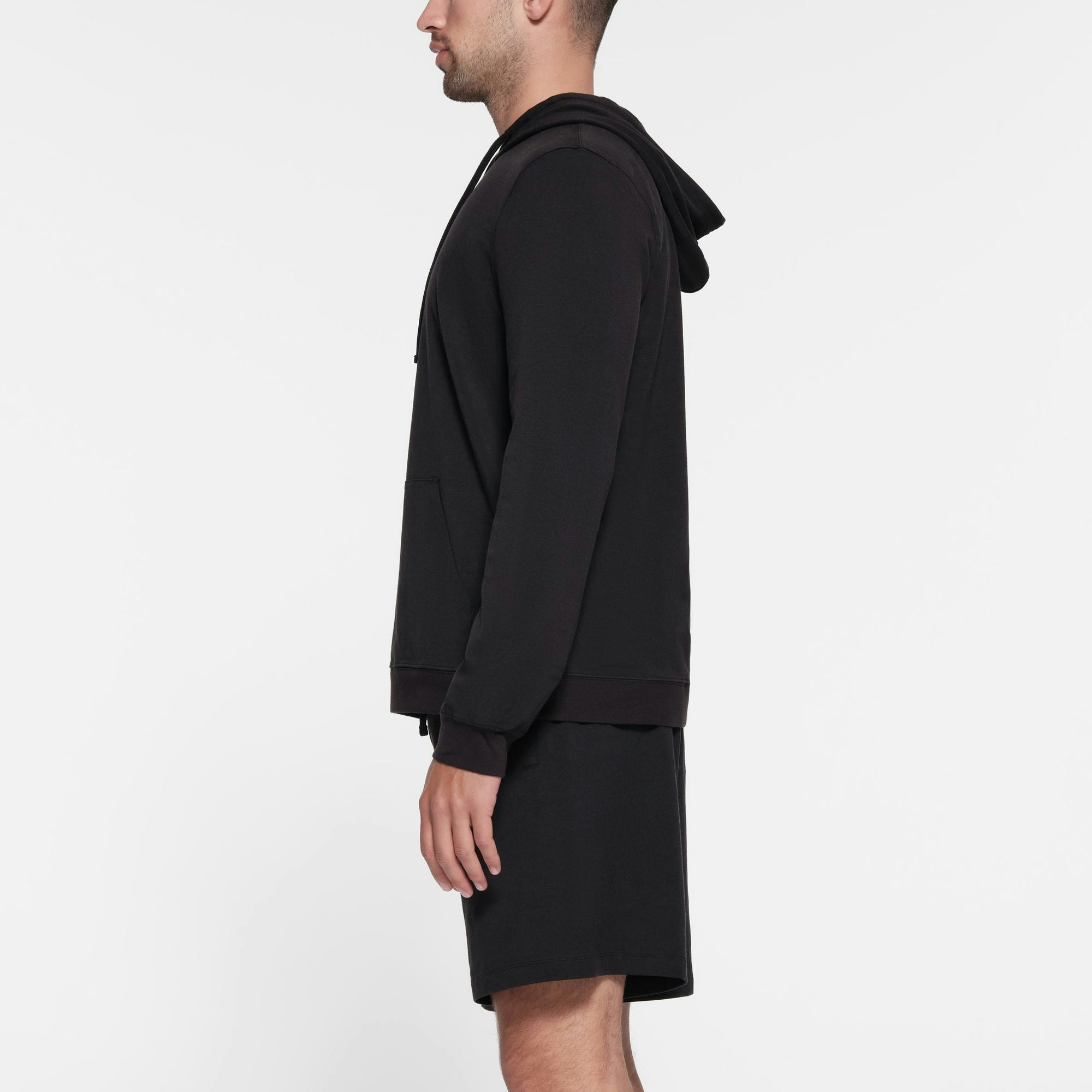 JERSEY LOUNGE MENS HOODIE | OBSIDIAN ON A MODEL SIDE VIEW