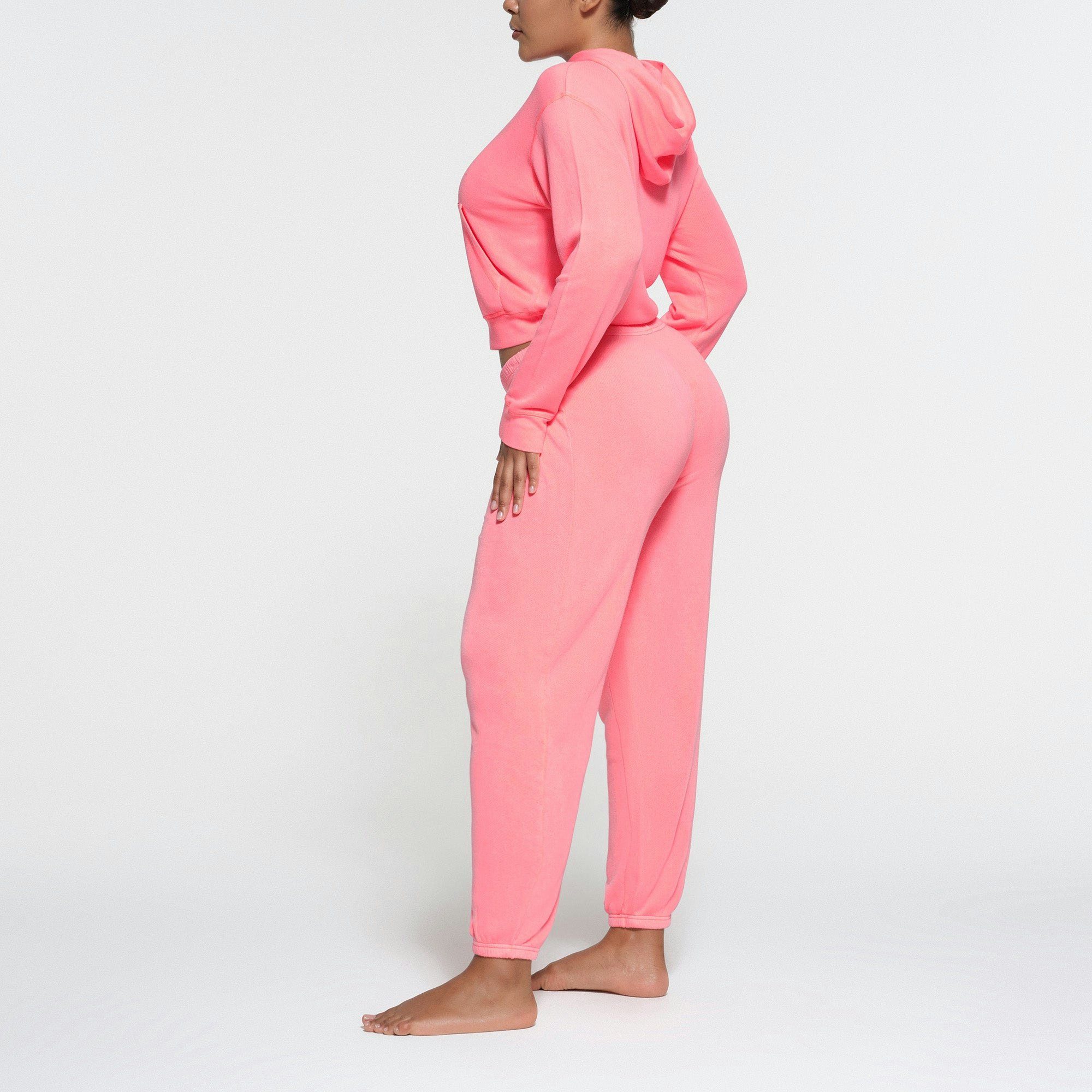 LIGHT FRENCH TERRY HOODIE | CORAL ON A MODEL SIDE VIEW