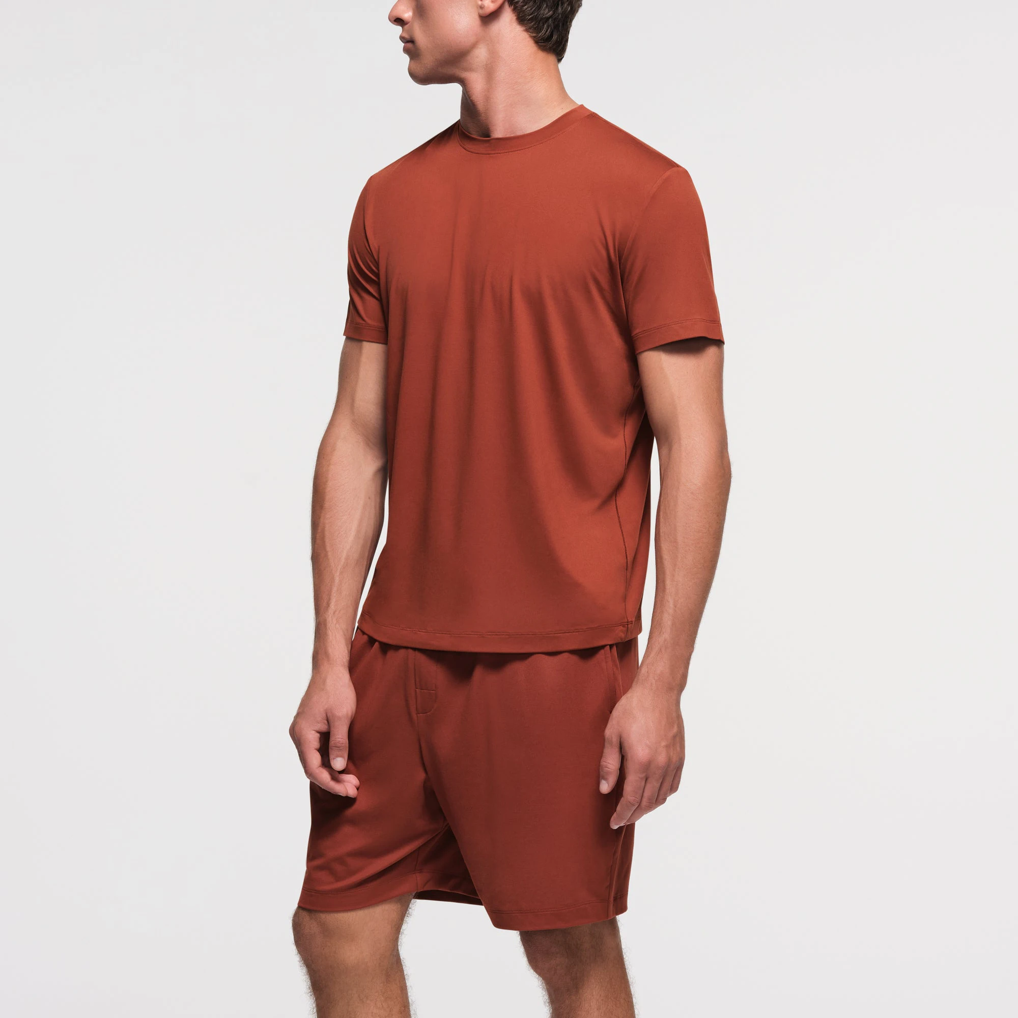 OUTDOOR JERSEY MENS CLASSIC T-SHIRT | RUST ON A MODEL SIDE VIEW