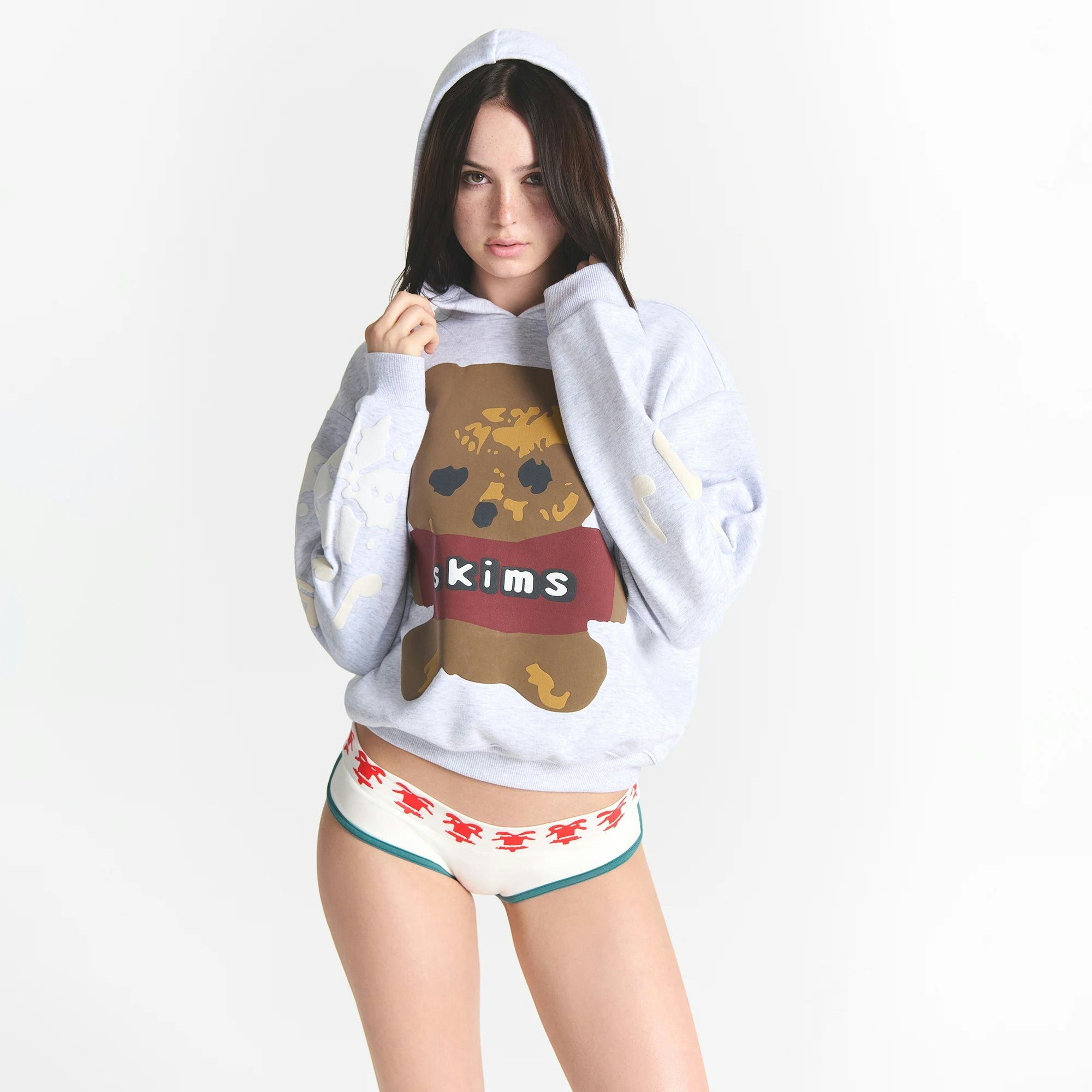 CACTUS PLANT FLEA MARKET X SKIMS COTTON FLEECE HOODIE | LIGHT HEATHER GREY TEDDY BEAR PRINT ON A MODEL FRONT VIEW @ | FOCUS: 0.0, 1.0, 0.9