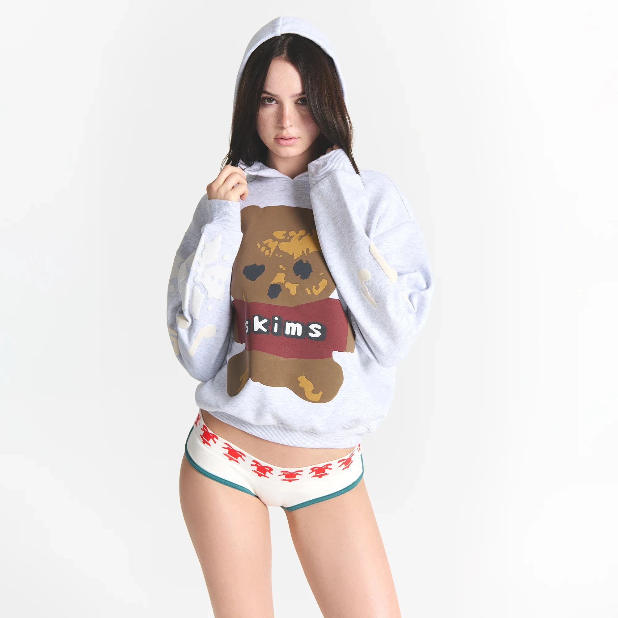 CACTUS PLANT FLEA MARKET X SKIMS COTTON FLEECE HOODIE | LIGHT HEATHER GREY TEDDY BEAR PRINT ON A MODEL FRONT VIEW @ | FOCUS: 0.0, 1.0, 0.9