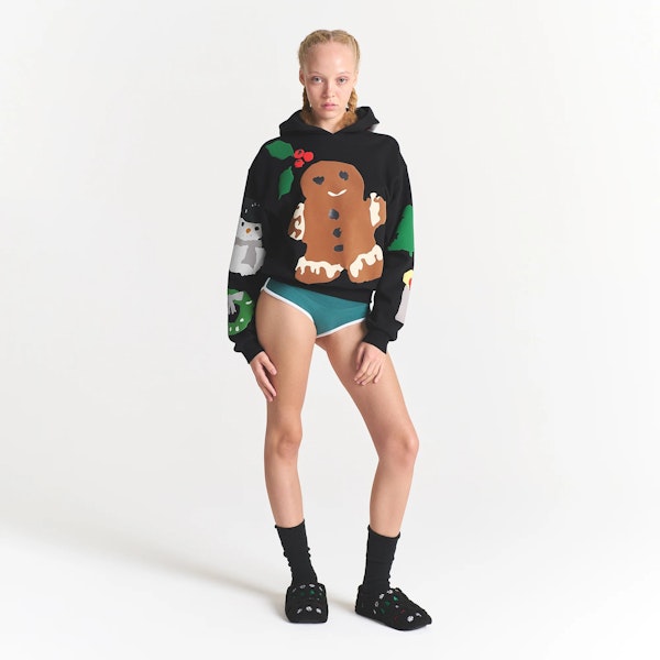 CACTUS PLANT FLEA MARKET X SKIMS COTTON FLEECE HOODIE | ONYX GINGERBREAD PRINT ON A MODEL FRONT VIEW @ | FOCUS: 0.0, 1.0, 0.9