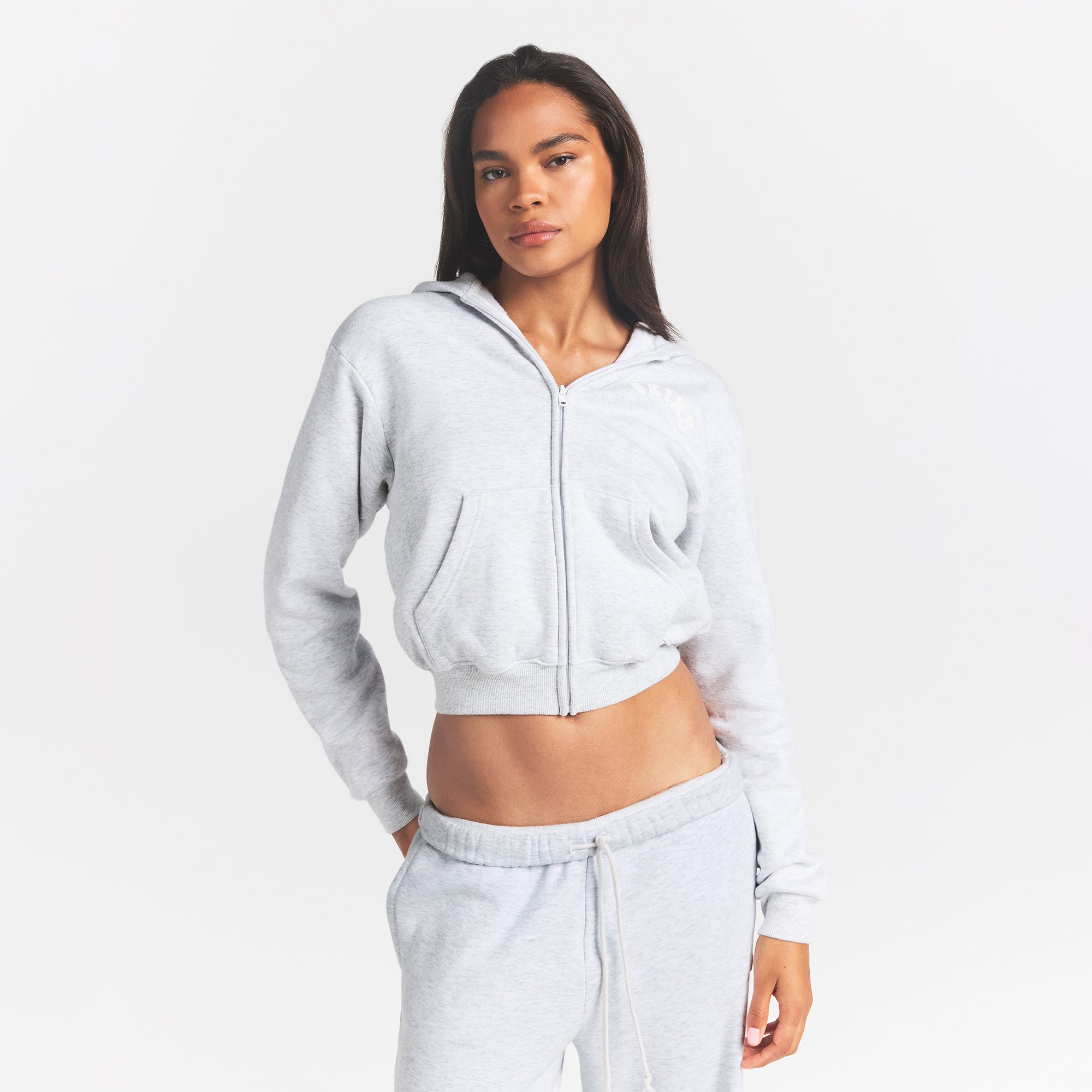 COTTON FLEECE CLASSIC ZIP UP HOODIE | SNOW ARCHED LOGO PATCH ON A MODEL FRONT VIEW