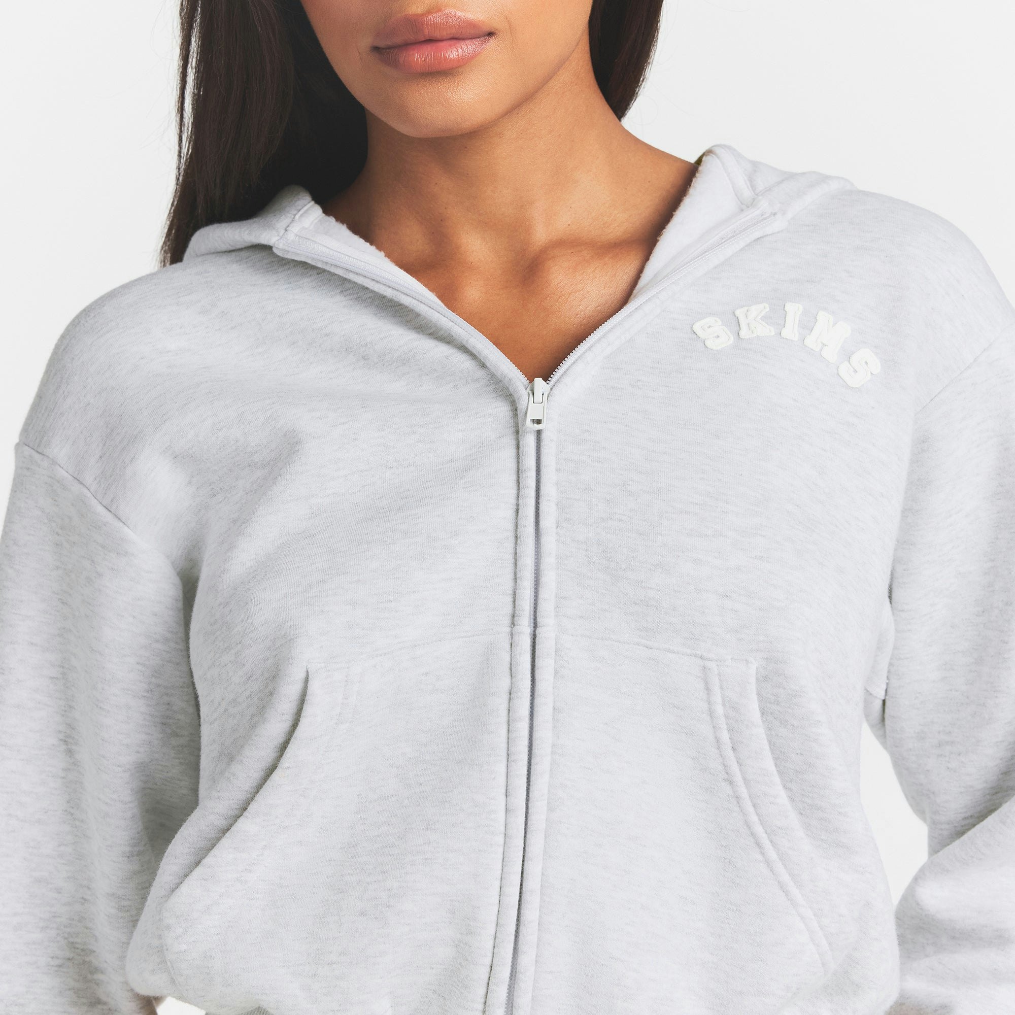 COTTON FLEECE LOGO CLASSIC ZIP UP HOODIE | SNOW ARCHED LOGO PATCH ON A MODEL FRONT VIEW @ | FOCUS: 0.0, 1.0, 0.9