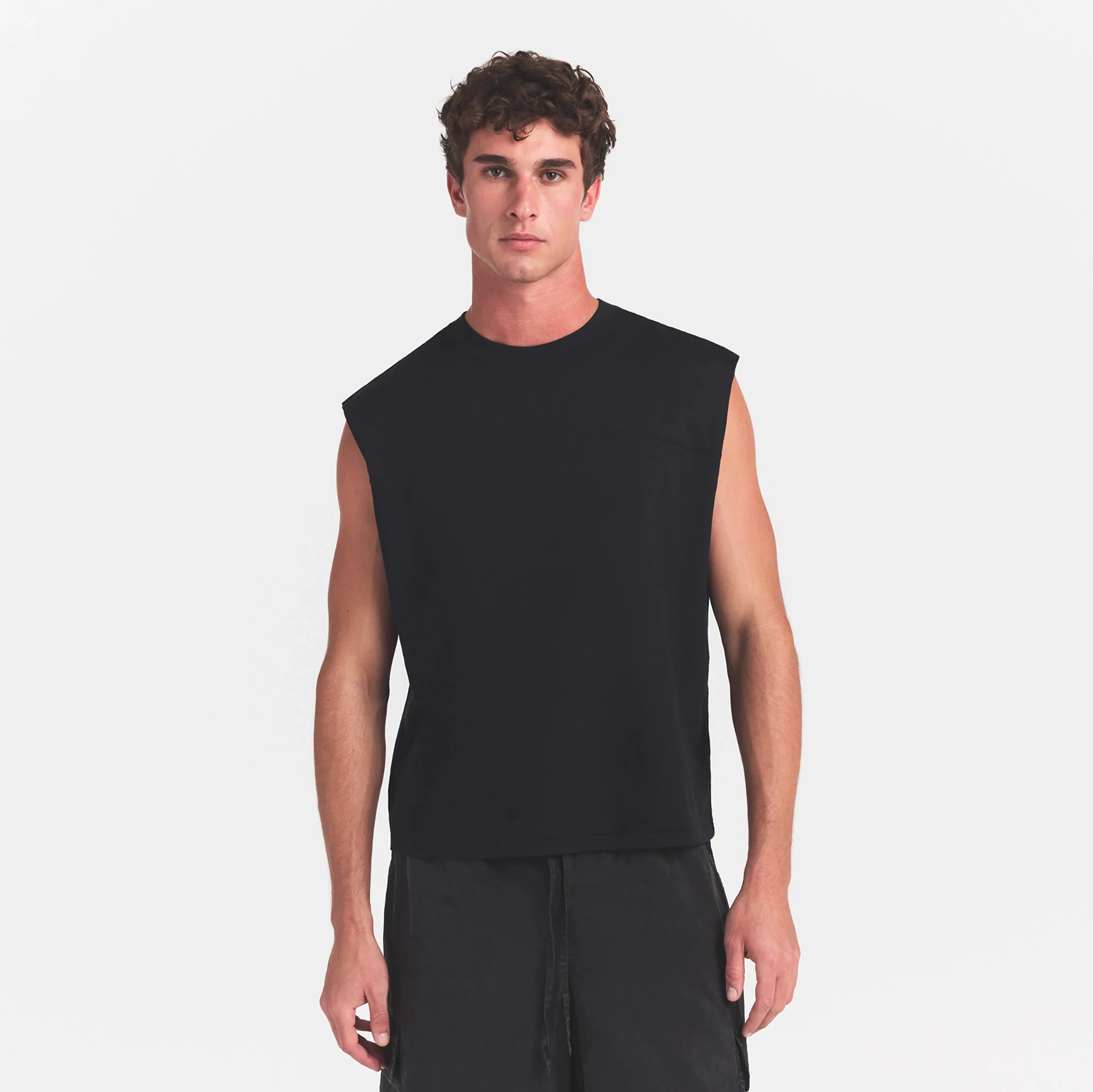 HEAVYWEIGHT COTTON MENS CROPPED MUSCLE TANK | OBSIDIAN ON A MODEL SIDE VIEW @ | FOCUS: 0.0, 1.0, 0.9