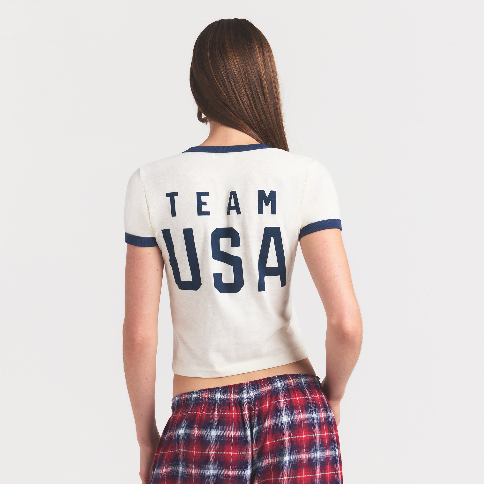 SKIMS FOR TEAM USA WORN IN JERSEY OLYMPIC SHRUNKEN T-SHIRT | ECRU ON A MODEL SIDE VIEW @ | FOCUS: 0.0, 1.0, 0.9