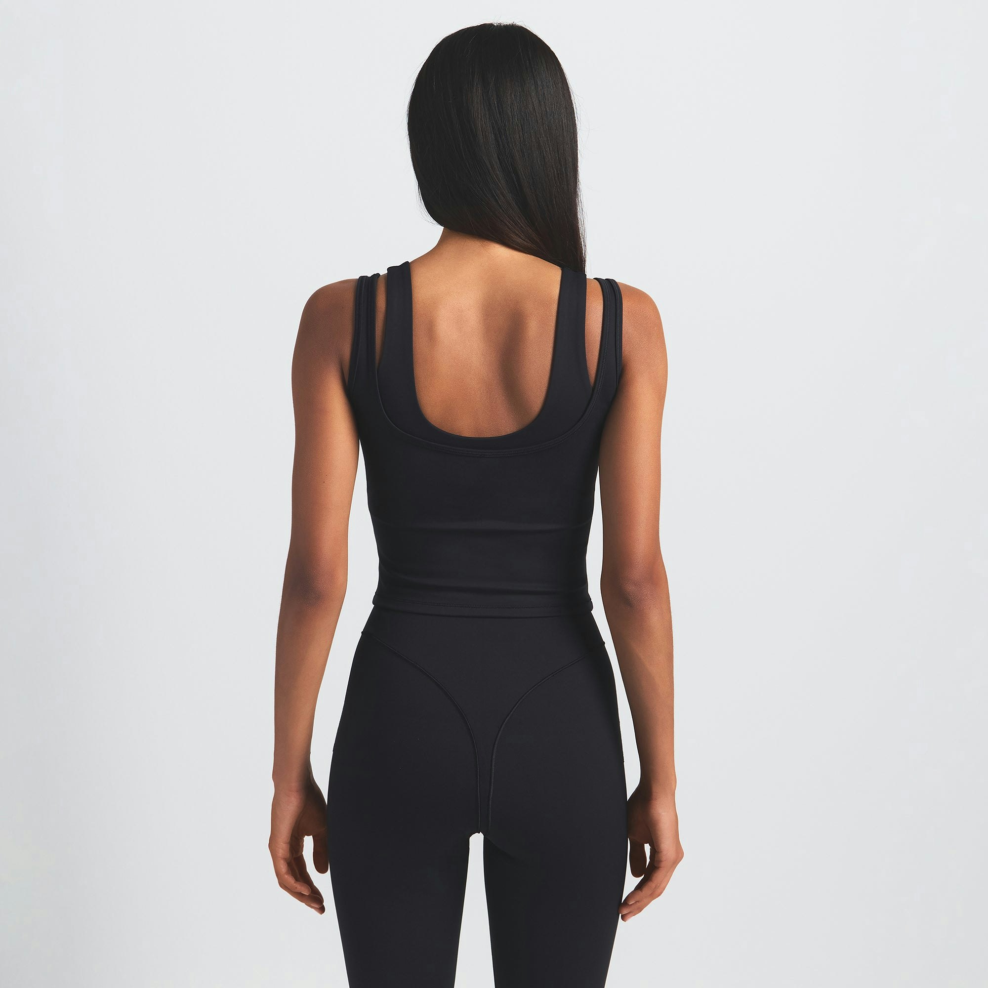 NikeSKIMS MATTE DOUBLE STRAP SCOOP TANK | OBSIDIAN ON A MODEL BACK VIEW @ | FOCUS: 0.0, 1.0, 0.9