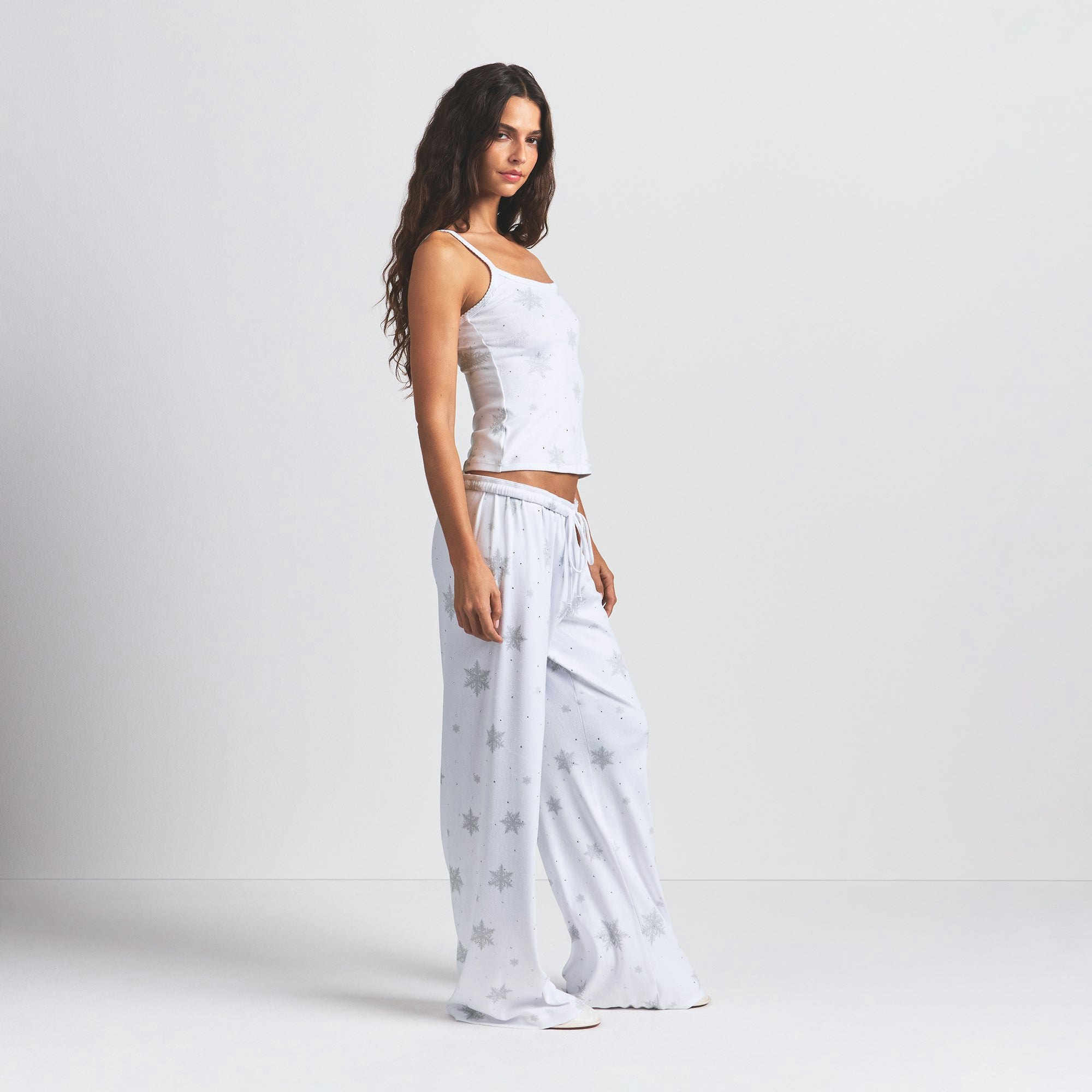 LOGO PLUSH POINTELLE RHINESTONE TANK | SNOW RHINESTONE PRINT ON A MODEL SIDE VIEW @ | FOCUS: 0.0, 1.0, 0.9