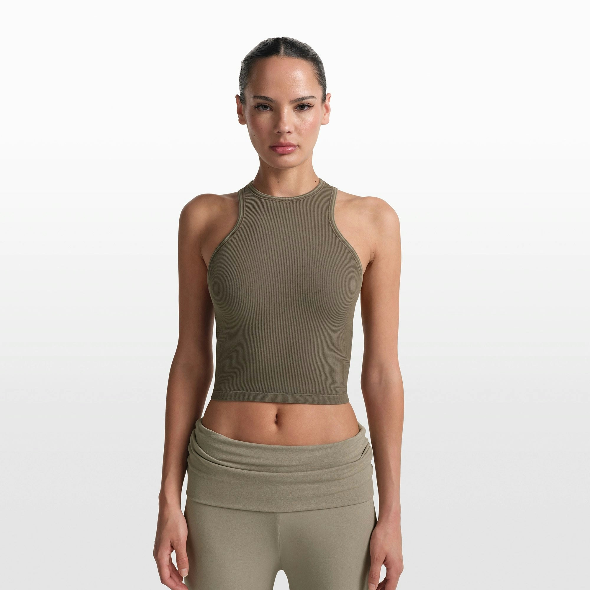 NikeSKIMS RIBBED SEAMLESS RACER FRONT TANK | DUSTY OAKMOSS/DUNE ON A MODEL FRONT VIEW @ | FOCUS: 0.0, 1.0, 0.9
