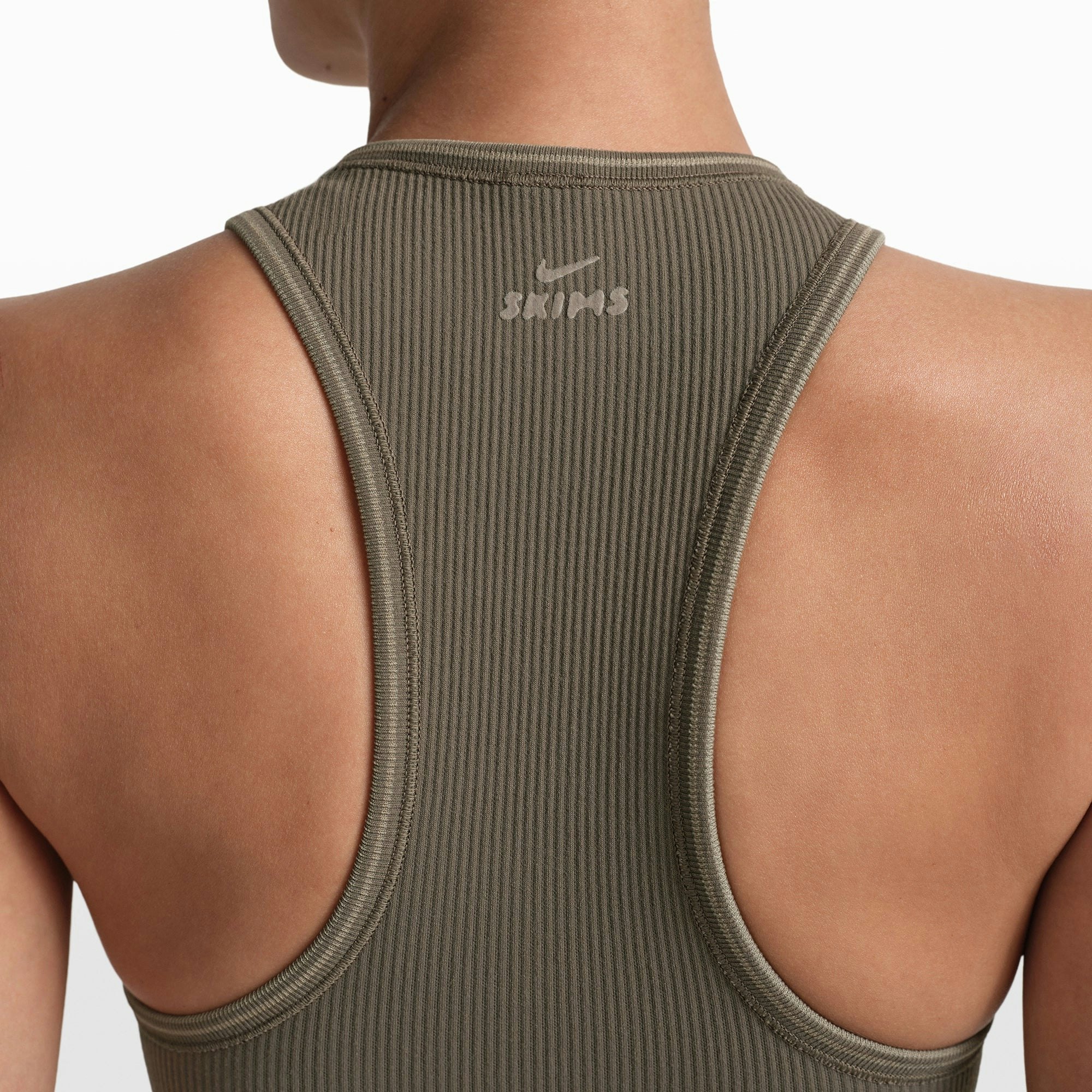 NikeSKIMS RIBBED SEAMLESS RACER FRONT TANK | DUSTY OAKMOSS/DUNE ON A MODEL FRONT VIEW @ | FOCUS: 0.0, 1.0, 0.9