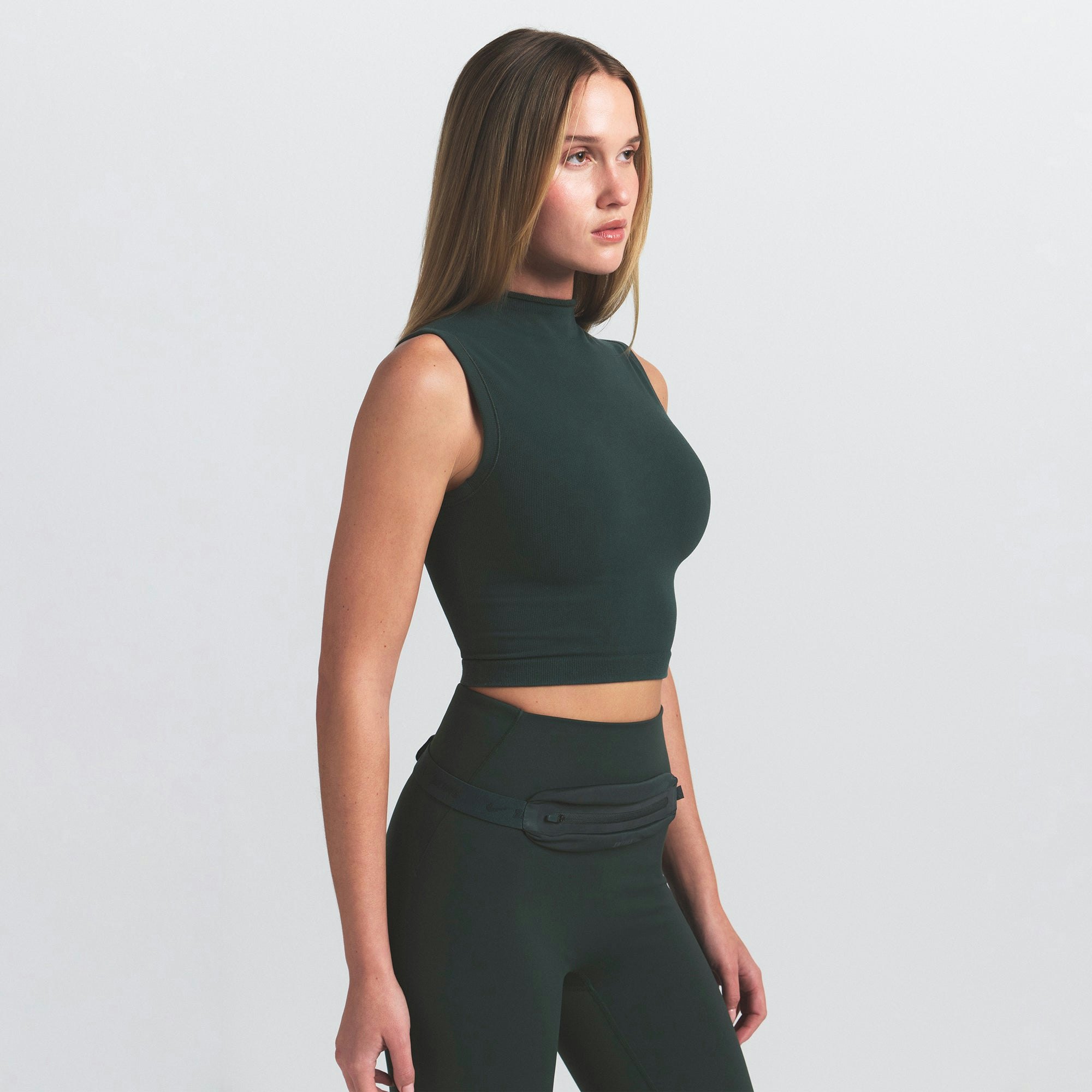 NikeSKIMS VINTAGE SEAMLESS MOCK NECK BRA TOP | DARK TEAL ON A MODEL SIDE VIEW @ | FOCUS: 0.0, 1.0, 0.9