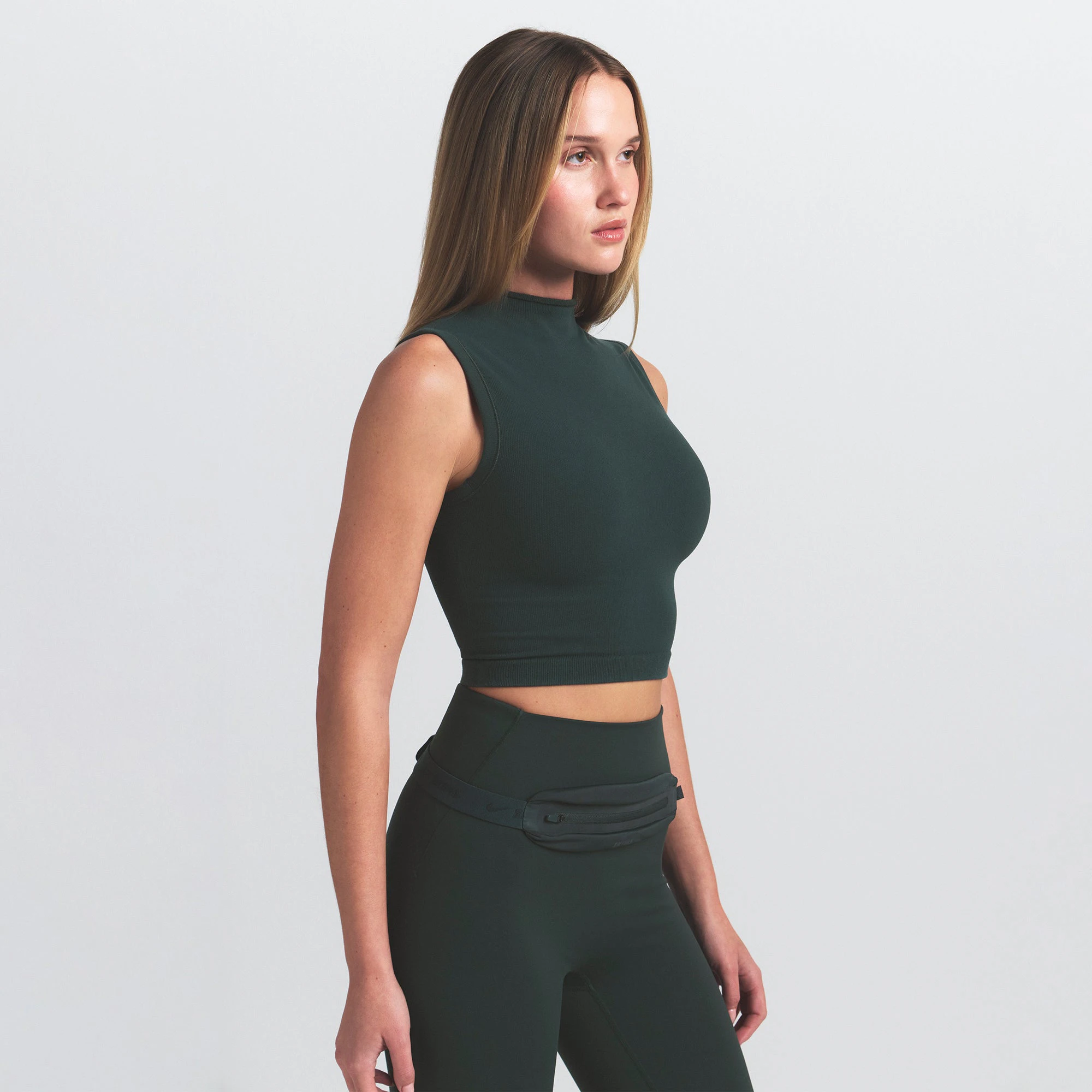 NikeSKIMS VINTAGE SEAMLESS MOCK NECK BRA TOP | DARK TEAL ON A MODEL SIDE VIEW @ | FOCUS: 0.0, 1.0, 0.9
