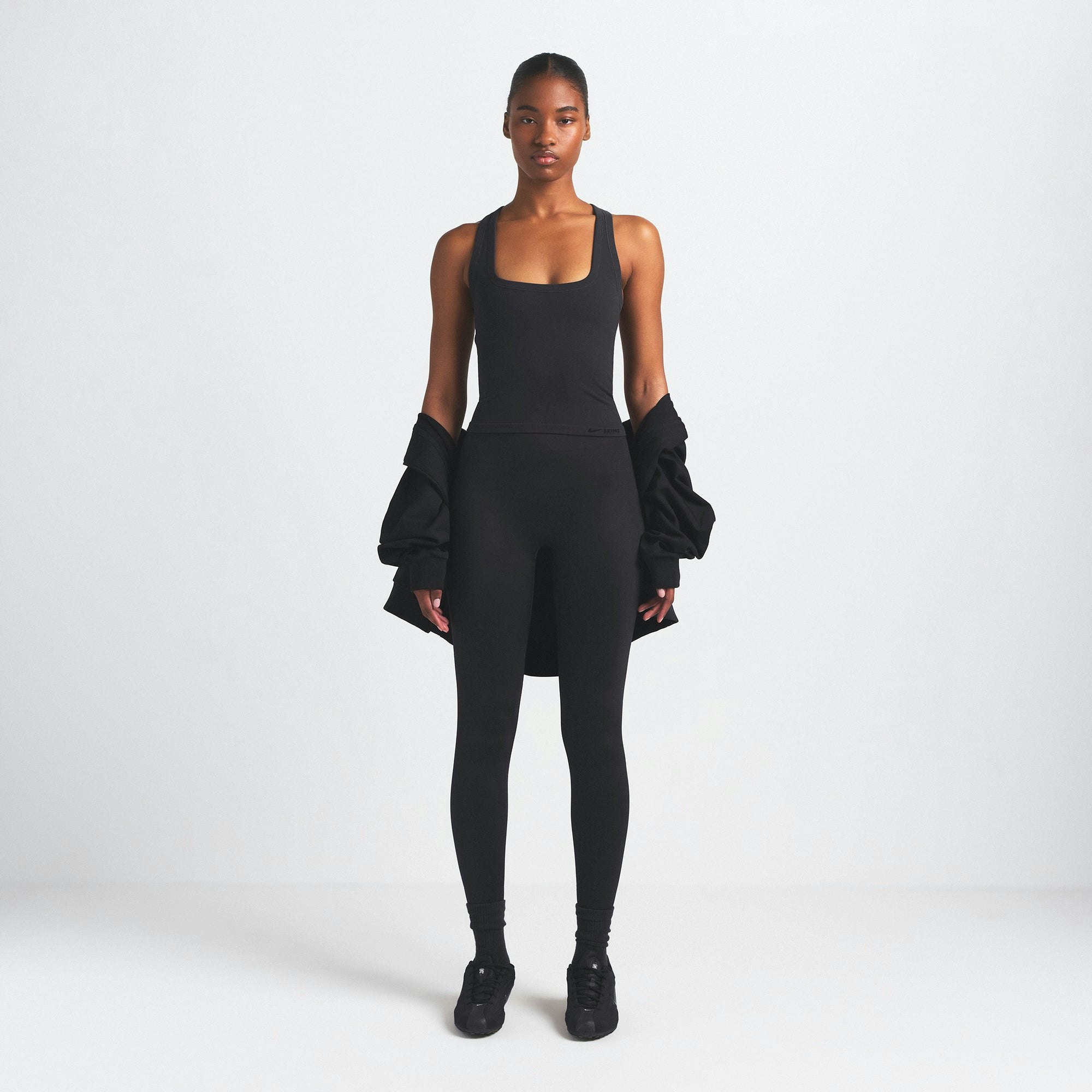 NikeSKIMS VINTAGE SEAMLESS RACER BACK TANK | OBSIDIAN ON A MODEL FRONT VIEW @ | FOCUS: 0.9, 0.1, 0.7